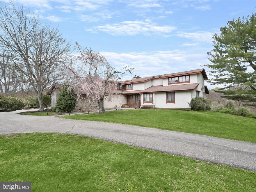 RARE OPPORTUNITY to own this Exceptional Estate in The Village of Town Center - Running Brook, in highly sought after Columbia, Howard County MD
This Contemporary Home designed by Architect Dallas Daniels, boasts five bedrooms, four full, and one half baths with over 7,100 finished square feet, three car oversized 1,016 sq. ft. side loading garage, perfectly sited on a sprawling 2.79 Acre lot, guarded by dense trees and filled in with beautiful green vista's, offering the ultimate in privacy. It is one of the highest elevation lots in Columbia.
The property is accessible by rare Dual driveways (Rte 108 Clarksville Pike and Amesbury Dr.)
Both driveway entrances usher you to a circular driveway, that when added to the long driveways, include space for approximately 20 parked cars. 
As you enter the property, you are greeted by a  marble tile entrance foyer. Step down to a colossal size sunken great room boasting a full stone wall wood burning fireplace, vaulted ceilings, recessed lighting, two skylights, wood ceiling beams, and brilliant hardwoods. Adjacent to the great room is a separate huge dining room which can easily accommodate large family holiday gatherings.  Large doors offer a seamless transition from inside to outside views connecting to a sunroom located off the dining room, which also connects to an attached outside screened in porch. A Gourmet size kitchen with large island with two built in cooktops, massive side by side built in refrigerator and freeze, double wall ovens, built in pantry with organizers and plenty of room for a table and chairs. Lateral to the kitchen is a cozy living room with yet another stone wall fireplace and two skylights. To the right side of the entrance foyer you will find the primary bedroom suite with attached sitting area, private balcony and attached luxury spa like bath featuring two spacious walk in closets with built ins, his and her vanities, soaking tub, and wide stall shower. Two additional bedrooms each with vaulted ceilings and double wide closets, a full hallway bath with tub shower, and a laundry room with washer and dryer, utility sink and built in cabinets, round out the main level. Ascend to the upper level via a custom staircase and be ushered by a sleek catwalk connecting right to a large guest bedroom with wood ceiling beams and attached sitting room, and a full hallway bathroom. On the opposite side of the catwalk, you will enter a library with built ins, wood ceiling beams and another stone wood burning fireplace with flagstone hearth. Another sunroom balcony, with walls of windows and a cathedral ceiling is accessible through a connecting door in the library. The lower level is 3/4 finished and is also ideal for entertaining family and guests and can easily accommodate a multigenerational living arrangement with the 5th bedroom and huge full bath with dual sinks, and two additional stall showers. A large family room with brick fireplace and sliders to the outside cement patio, expansive recreation room with bar with sink, dishwasher, oven range, refrigerator and another set of sliders out to the large cement patio are the focal rooms of the lower level. Existing rooms await your potential choices of a large exercise room, home office, den, playroom/hobby room, huge cedar closet, and multiple storage room options. Close proximity to major route's, Columbia Downtown Lakefront, Retail, restaurants, walking paths, parks and recreation. Listed in "AS IS" condition and priced accordingly. Investors come see this one- you'll be glad you did. Open Saturday June 15th, 2024 from 1-4pm.