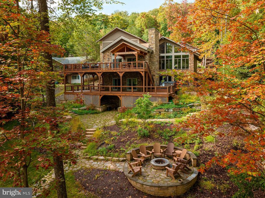 This stunning home is truly a lakefront masterpiece. Completely remodeled with a large addition in 2017. It feels so warm and inviting from the moment you enter; the whole layout is very well thought out. The slate floors, hardwood floors, granite counters, and a floor-to-ceiling wood burning fireplace which can be enjoyed in both the kitchen and dining area are just a few of the many great features this home offers. With three levels of living space, six bedrooms (four of which are en suites), a beautiful loft area and a lower-level family room, this home is ideal as a full-time residence or vacation rental. The abundance of windows allows you to enjoy the beauty of Deep Creek Lake from almost every room during any season. If the interior isn't enough to impress you, let's walk outside where you can enjoy your 103' of lakefront, type A dock, multiple lakefront decks, hot tub, extensive hardscape and an elaborate fire pit. The list keeps going...the location is perfect being about half of a mile to the Main Street slope at Wisp Resort, and just a few miles to Lodestone Golf Course and ACSI Whitewater course. This is truly a four-season home that leaves nothing to the imagination, it's simply breathtaking!