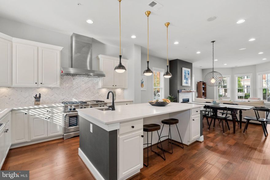 This is the home you've been waiting for!! With over 4,000 sq ft of luxury living at every turn! This 5 bed 4.5 bath End unit townhome in Potomac Yard is truly one of a kind! Upon entering the front door, you are greeted with cascading hardwood floors that lead to an open-concept living area. The main level is adorned with 10’ ceilings, large windows that let in plenty of natural light, and a newly refaced cozy fireplace with a live wood edge and marble surround that adds a touch of warmth and elegance to the space.
With over $200k in upgrades, you will be hard pressed to find any other home in this neighborhood nearly as refined as this one! See full list of upgrades in the documents section.  Kitchen updated in 2022 to include gorgeous quartz countertops with  marble, chevron tiled, backsplash! The center island boasts 40 sq ft of prep space, with prep sink, built in beverage cooler, and bar seating! Well-appointed mud room located just off the kitchen, includes custom built in shelving in the pantry as well as additional coat closet, all of which takes you to your rear patio oasis! Brand new patio pavers installed 2023,  w/direct gas line to the patio area that makes for far more convenient grilling experiences, or you can hook up your favorite fire feature!! Just beyond your patio is the detached 2 car garage (side loading) w/ample storage and In-Law suite above, giving you and your guests an additional 400 sq ft of living space with it's very own HVAC/Hot water heater, bedroom, full bath and mini-kitchen set up.
Primary suite is complete with custom built-in’s  across both walk-in closets, en-suite that includes a new floating tub, white marble floor/wall tile, frameless shower, new vanity/lighting and even added in additional shelving for more storage! Custom bookshelves added to the 3rd level family room, and built-in surround sound across all 4 levels! Dual HVAC units installed in 2020 and 2021. 4th level rec room w/full wet bar and double-side gas fireplace! Enjoy a multitude of outdoor living spaces, including watching fireworks from your oversized roof deck terrace!  Too many upgrades to list, come see for yourself why you can’t pass up this opportunity to move in to  this turn key home!!
Finally- Location matters. This is a rare opportunity to own the nicest, most upgraded home in all of Potomac Yard, and getting in prior to all the future community  developments is going to be a decision you will be glad you made! Caps/Wizard area in progress to be built by/around 2028,  walk to Potomac Yard Metro Station (now open), Amazon HQ2 and Reagan airport are only a few mins north, and Del Ray is only 4 blocks west- you truly have it all here! Welcome Home!