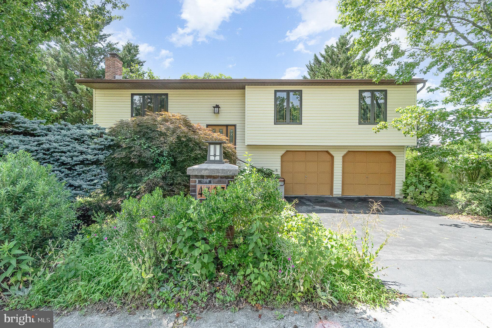 Introducing an exceptional opportunity to reside in sought-after Centennial Acres Community. This updated bi-level home offers approximately 1,800 square feet of living space, featuring three bedrooms, two and a half bathrooms, and spacious open-concept rooms throughout. Attention to detail is evident in the impressive eat-in kitchen, which is equipped with hardwood flooring, recessed and pendant lighting, custom high-end oak cabinetry, quartz countertops, ceramic tile backsplash, stainless steel appliances, and a sizable L-shaped center island with built-in cabinets, breakfast bar, and wine rack. The adjacent dining area includes hardwood floors, crown molding, and an atrium door that opens onto a rear wooden deck complete with an arbor and removable shade canopy—ideal for entertaining. The living room is bright and welcoming, highlighting hardwood floors, crown molding, a large picture window, and abundant natural light. The primary bedroom features carpeting, display shelves, a walk-in closet, and direct access to an en-suite bathroom with skylight and a tub/shower combination. Two additional generously sized bedrooms with ample closet space and a main bathroom, also with skylight, towel warmer, and a tub/shower combo, are located on the main floor. The lower level presents a comfortable family room with a brick wood burning fireplace, wall-to-wall carpeting, an atrium door leading to the stamped concrete patio and rear yard, The lower level also offers a powder room, storage closet under the stairs, and a laundry/utility room with washer and dryer included. Convenient access to the attached two-car garage enhances functionality. Situated on a .22-acre lot, this property offers scenic mountain views and beautiful landscaped grounds. For further information or to schedule a private tour, please contact us today.