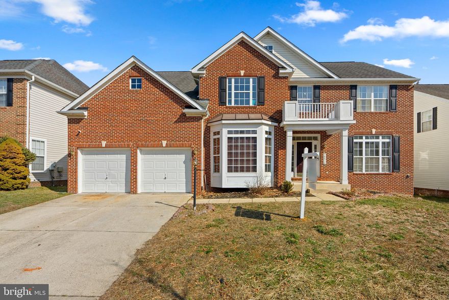 Has an assumable FHA mortgage! Recently reduced by $15,000, ask how you may qualify for up to $10,000 in grant assistance to make this stunning property yours!

This beautifully updated 5-bedroom, 3.5-bath, 2-level brick-front Colonial blends timeless elegance with modern comfort. Featuring a brand-new furnace on the main level, fresh paint throughout, and new carpet, this home is truly move-in ready.

The classic brick façade, spacious 2-car garage, and large deck overlooking a fully fenced backyard set the stage for comfortable living and entertaining.

Inside, enjoy gleaming hardwood floors, a gourmet kitchen with granite countertops, stainless steel appliances (including a 4-door fridge, gas cooktop, and double oven), and a sunlit morning room that flows into the backyard. The dramatic 2-story family room is anchored by a striking stone-surround fireplace.

Upstairs, the luxurious owner's suite boasts hardwood floors, a walk-in closet, and a spa-inspired bathroom with a soaking tub, separate shower, dual vanity, smart toilet, and a wall-mounted fireplace for added comfort. Generously sized secondary bedrooms offer ample storage.

The fully finished basement offers endless possibilities with new carpet, a custom wet bar, double-wide rear entrance, and multiple flexible spaces for a home theater, gym, guest suite, or more.

With $15,000 in price reductions and potential buyer grants available, this is a rare opportunity to own a sophisticated, meticulously maintained home. Schedule your private tour today!