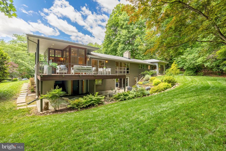 New Listing! Redesigned, rebuilt and reimagined by local architectural firm, Archeon Architects. Sited on over 3/4 acres on a quiet cul de sac in close-in Bethesda, this 5 bedroom, 4.5 bath mid-century modern home is uniquely beautiful boasting loads of light with skylights and floor to ceiling windows overlooking the serene backyard throughout the main floor and plenty of living space and storage. The expansive kitchen features a large, granite kitchen island, top of the line stainless appliances and lots of natural light with a beautiful wall of windows. The dining room and living room feature floor to ceiling windows, transoms, gorgeous wood trim and French doors leading to the Ipe wood deck overlooking the expansive private yard. The home's expansion also includes a new primary bedroom offering views of and access to the backyard and a beautiful ensuite bathroom with a large shower and soaking tub, and two large walk-in closets. The first level also features skylights for natural light, a bedroom with an ensuite bathroom and two additional bedrooms sharing a hall bathroom. The walk-out lower level leads to a patio with beautiful hardscaping and landscaping. The lower level boasts a large family room with high ceilings and a gas fireplace, a 5th bedroom, 4th full bathroom, and plenty of storage. This home is move-in ready - just gorgeous! Whitman HS, Pyle MS and Burning Tree ES Cluster. Yes, you can have it all!