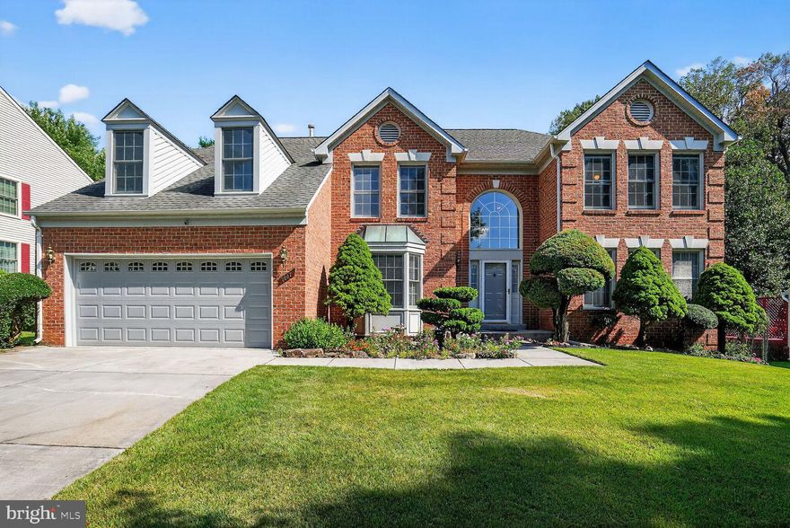 Nestled in a quite, prestigious neighborhood, this stunning model home meticulously maintained by the original homeowners is the largest of the builder floorplans with an open architectural design and soaring spaces that create an exceptional visual appeal throughout. Enter through a magnificent two-story foyer featuring an elegant curved staircase. Handsome double doors  lead to a private office with an expansive bay window, while across the foyer, a sunny living room with crown molding leads seamlessly to an elegant formal dining room with tasteful wainscoting.  The heart of the home is the gourmet kitchen, complete with granite countertops, abundant  counter space, pantry, and greenhouse window. the glass-enclosed breakfast nook brings the outdoors in with vaulted skylight ceilings and private wooded views. the family room boasts a solid masonry fireplace. vaulted ceilings, second floor Juliet balcony, and  floor to ceiling windows and French door that leads out to a custom deck with built-in benches. The bedroom level overlooks both the foyer and family room below. the master suite is a true retreat, featuring a luxurious bathroom with double vanities, his and hers walk-in closets, an oversized deluxe Jacuzzi tub, and a separate glass-enclosed shower. Three additional generous bedrooms, each ample closet space and one with a finished a bonus room for a kids' hideout or storage, share a well-appointed full  bath with a double vanity. Finished walkout lower level adds an additional 1,404 sf for a total of 4,701 finished sf with welcoming windows and French door, a flex room for a second office or craft room, a third full bath with shower, oversized recreation room, and 2 spacious storage/workshop rooms including a deep work sink. the exquisitely landscaped grounds feature flower and fruit trees, gardens, and colorful seasonal blooms throughout the wooded backyard, creating a serene outdoor retreat. This immaculately maintained home features fresh interior and exterior paint, 2025 new microwave, 2024 new insulated garage door with quiet motor and myQ remote connectivity, 2024 washer and dishwasher, freshly painted deck, 2022 HVAC motor replacement, 2016 renovated kitchen with countertops, backsplash and appliances, and 2015 heat pump installation.  A nationally renowned elementary school in the top-ranked Montgomery County Public School system is within steps out the front door with a huge playground  and a bus stop to Richard Montgomery High School's International Baccalaureate Program. Easy access to Shady Grove Metro Station and major highways including I-270, I-370, and ICC ensures convenient commuting, while nearby amenities include Needwood Golf Course, Mansion, and Lake within Rock Creek Regional Park with access to boating, picnicking, hiking, biking, Smith Educational Center, Meadowside Nature Center, and Rock Creek trail to the National Zoo, all within walking/biking distance via paved pathways and dedicated crosswalks.