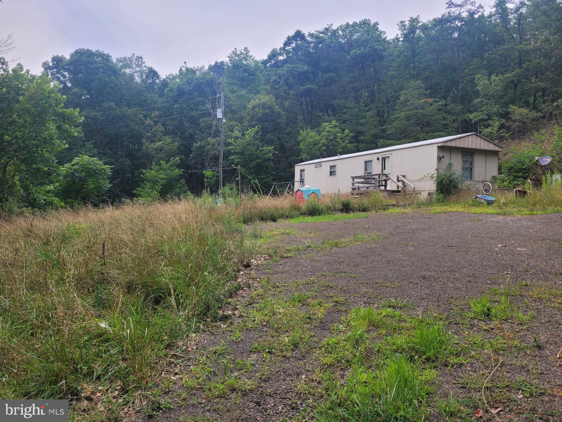 GET THE MOST FOR YOUR $$$$! 62.5 UNRESTRICTED ACRES WITH WELL, MULTIPLE SEPTIC'S, ELECTRIC, AND TONS OF ROAD FRONTAGE ON OLD RT 55 JUST MINUTES FROM MOOREFIELD WV, RIGHT OFF CORRIDOR H. THIS PROPERTY HAS ABOUT EVERYTHING YOU COULD ASK FOR, IT HAS A DECENT ROAD INTO THE PROPERTY RIGHT OFF OF A STATE MAINTAINED ROAD, IT HAS A YEAR ROUND STREAM THAT REMAINS FLOWING EVEN DURING A DROUGHT, IT HAS MULTIPLE BUILD SITES, SAVE YOURSELF SOME $$$$ ON PERMIT'S, DRILLING A WELL, INSTALLING A SEPTIC, BUILDING A ROAD, ALL THAT IS ALREADY IN PLACE!!!!! BEST OF ALL, THERE ARE NO RESTRICTIONS, EXCELLENT HUNTING, THERE ARE PLENTY OF TROPHY WHITETAIL'S, TURKEY, BEAR ETC.........THIS PROPERTY WAS ONCE USED AS A SMALL MOBILE HOME PARK, ONE MOBILE HOME IS IN GOOD SHAPE, ANOTHER IS IN DECENT SHAPE, THERE ARE A FEW OTHERS THAT WOULD NEED TORN DOWN OR REMOVED. THE POSSIBILITIES ARE ENDLESS WITH THIS PROPERTY, CALL TODAY, WON"T LAST LONG! JUST 2 HOURS FROM WASHINGTON D.C.!!!!
