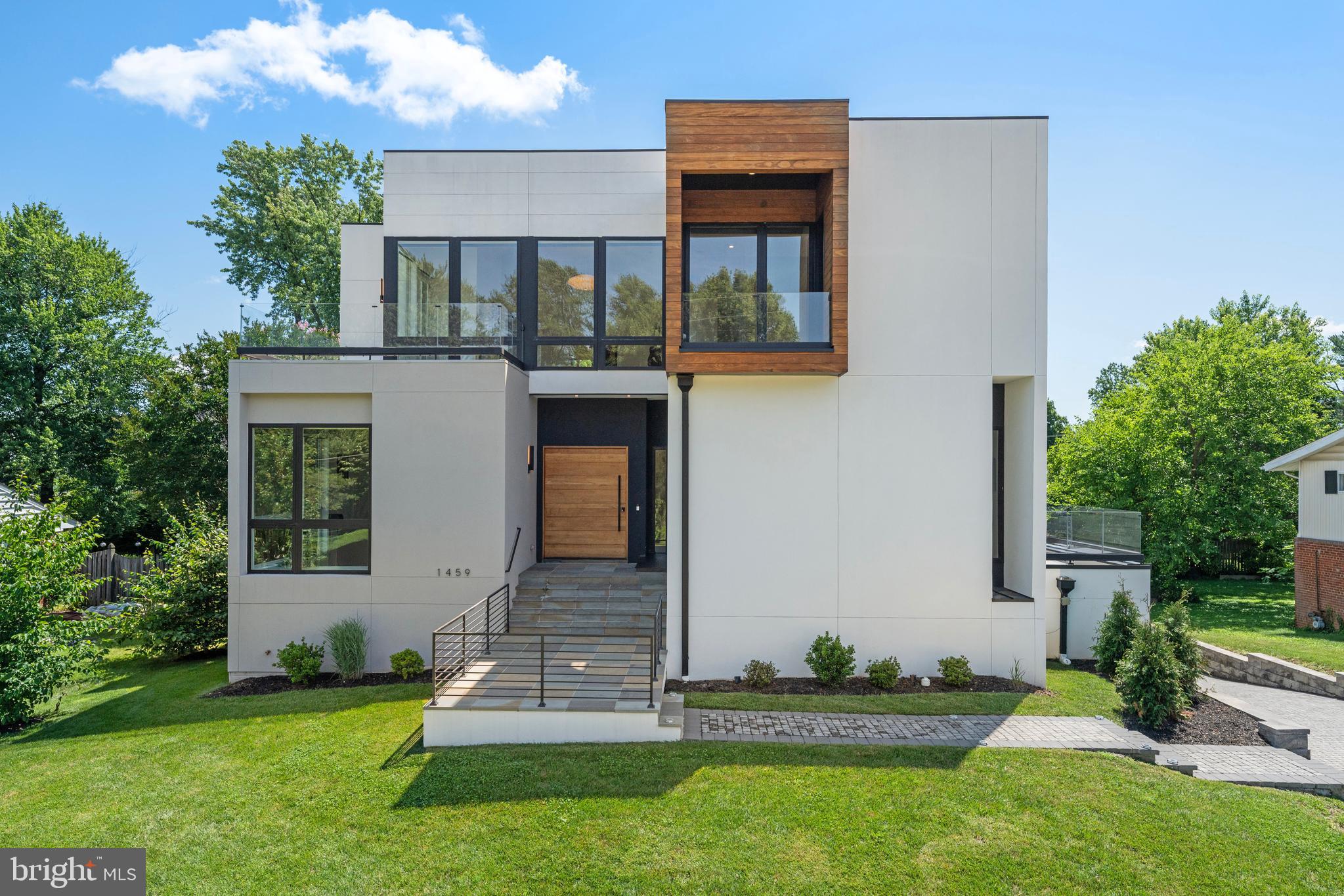 A striking modern masterpiece in the heart of McLean, 1459 Dewberry Court seamlessly blends cutting-edge architecture with luxury finishes and thoughtful design. Built in 2022 and offering over 8,100 square feet of refined living space, this contemporary residence showcases a rare combination of sophistication, comfort, and style.
Step inside to soaring ceilings, wide-plank hardwood floors, and dramatic open-riser stairs—all anchored by sleek lines and abundant natural light. The main level features a bedroom suite and a dedicated home office, along with an open-concept living area centered around a state-of-the-art kitchen outfitted with custom Miele and Liebherr appliances.
Upstairs, the luxurious primary suite enjoys beautiful eastern exposures. Two additional bedroom suites complete the upper level. The lower level offers a full exercise room, Bedroom Suite, Recreation area with kitchenette and walk-out access to the secluded backyard—ideal for both entertaining and everyday enjoyment.
Additional highlights include a private elevator to all three floors, multiple balconies throughout the home, and a 3-car garage. Perfectly situated on a quiet cul-de-sac, this home delivers stunning design and modern luxury in one of McLean’s most desirable locations.