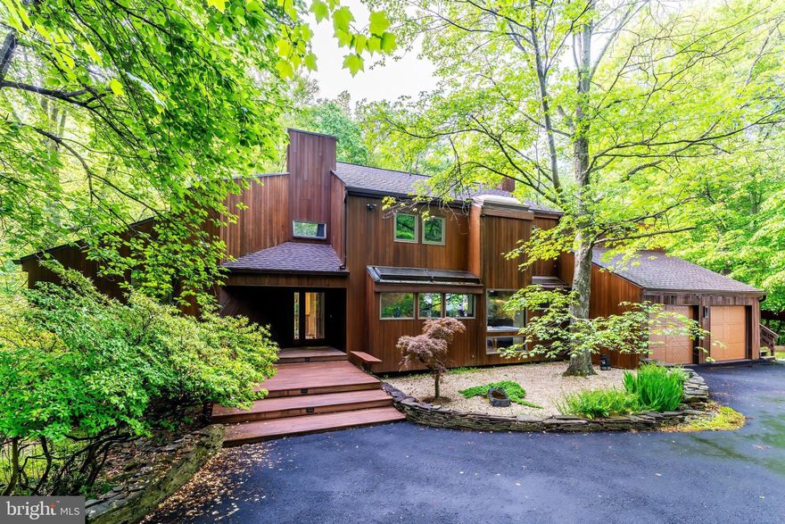 Join us this Friday, 5/23 from 5:30-7:30PM for an Open House! Welcome to 9700 Beach Mill Road—a rare opportunity to own an elegant and timeless contemporary designed by architect Richard Compton. This meticulously maintained 4 bedroom, 3.5 bath home is tucked away on a tranquil 2 acre lot and bordered by 10 acres of protected Virginia Land Trust and Resource Protected Area, offering privacy and serenity all while being just minutes from  the Great Falls Village Centre.

As you step inside, you're greeted by light-filled interiors and serene views of the surrounding landscape. Expansive windows throughout the home create a seamless connection to the outdoors, blending indoor comfort with natural beauty. Whether you're unwinding in a quiet moment or hosting guests, the well-designed layout offers the perfect balance of relaxation and functionality.

The two-story living room featuring a centerpiece fireplace is ideal for cozy evenings, while the formal dining room off the kitchen sets the stage for memorable dinners. The kitchen features stainless steel appliance, granite countertops, and stunning wooden built-ins. The large home office offers a built-in desk, ample storage, and expansive windows that frame beautiful natural views—an inspiring and peaceful setting for remote work or virtual meetings.

Upgrades throughout the home include gleaming hardwood floors, skylights, fresh paint, new carpet, updated lighting, and a stunning 2024 main-level addition—offering a full bedroom and bath perfect for guests, a second family room, or a rec space.

Upstairs, three spacious bedrooms include the primary suite with a spa-like en-suite bath, a generous walk-in closet, and a versatile bonus room ideal for a nursery, home office, or art studio. A conveniently located laundry room adds everyday ease.

Step outside to expansive decks designed for seamless outdoor entertaining, or soak in the beauty of the setting from the new side deck featuring a saltwater hot tub. Here, birdsong replaces background noise, and wildlife becomes your daily company.

The newly resealed two-car garage includes an electric vehicle charging station and ample storage space. Just off the garage you'll find the Generac 10kW backup generator and a wood shed.

Located in the highly coveted Langley High School pyramid and just minutes from Great Falls Village Centre, Tysons Corner, and the GW Parkway, this rare offering delivers the perfect blend of natural harmony, refined living, and accessibility.


Welcome home to your private sanctuary.