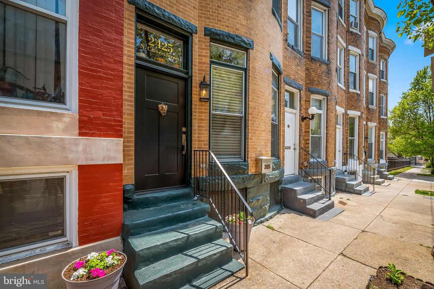 AGENTS PLEASE FOLLOW OFFER SUBMISSION INSTRUCTIONS IN DOCS.  Owners prefer a quick closing and do not need any post settlement occupancy.

Welcome to 2425 N. Calvert St. This three story bow front townhouse is awaiting her new owners. Fantastic location in the heart of Historic Old Goucher and Charles Village. This coveted location has so many things to offer including walkability to Penn Station, Hopkins Shuttle, public transportation, award winning restaurants and cocktail bars, Waverly Farmers Market, supermarkets, and best of all community! The owners have loved this home and location for so many reasons including multiple playgrounds and elementary schools within a block, The Village Learning Place library that hosts toddler story time, yoga and free community events year-round, one block from the Old Goucher community garden, where you can maintain a plot of your own if you outgrow the two raised beds in the backyard. Directly across the street is the Waller Gallery and just a few blocks  to MICA, you’ll be immersed in a thriving creative community. Move in before summer to enjoy the neighborhood sidewalk concerts, cultural parades, makers markets, and  outdoor dining at award-winning restaurants and local breweries including Mama Koko's, Chachis, Clavel, Faddensonnen, Sophmore Coffee, Kong Pocha, Dutch Courage & WC Harlan. 

The first floor has a spacious light filled living and dining room with exposed brick hearths, convenient powder room and modern kitchen. The second floor has a spacious primary suite with walk-in closets and luxurious spa bath with double vanity, soaking tub, separate shower and linen closet plus an additional bedroom. The third floor has two generous bedrooms, full bath and a skylight over the stairs which floods the center of the home with natural light. At the back of the house is a large fenced rear yard with deck, raised planting beds and detached garage for your two or four wheeled toys or projects. The garden is thoughtfully planted with colorful perennials that will bloom year after year. 

This home may qualify for the Johns Hopkins Live Near Your Work grant, offering significant down payment assistance for eligible buyers. Located in the Charles Village Special Benefits District FY 2024/25 Annual Tax $375.00.