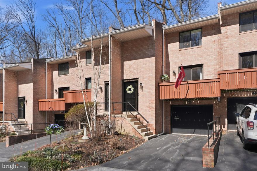 Welcome to 628 North Lemon Street, a beautifully maintained brick townhouse ideally located in Media Borough, within the private, and tucked-away community of Hickory Valley. Set in a peaceful, park-like setting with mature landscaping and abundant wildlife, this two-story home offers a rare blend of tranquility and everyday convenience.

The home features 2 bedrooms, 2.5 bathrooms, and thoughtful updates throughout. Upon entry, a welcoming foyer showcases terracotta tile flooring and whitewashed exposed brick, leading seamlessly into the main living areas. The main level offers a bright living and family room with sliding doors to a front deck and balcony, perfect for relaxing and enjoying scenic views.

The kitchen includes a breakfast bar and is equipped with a built-in microwave, stove, and refrigerator. It opens to the dining and family area, where a wood-burning fireplace and sliding doors to the rear patio and yard create an ideal space for entertaining, outdoor dining, or simply enjoying the serene surroundings.
Upstairs, the spacious primary suite features a private bathroom, a walk-in closet, and additional closet space. The second bedroom is equally generous in size and also includes its own private bathroom and multiple closets, offering excellent flexibility for guests, family members, or a home office.

The lower level includes a partially finished basement with a den or office area, laundry facilities, utility and storage rooms, and direct access to an attached one-car garage. The basement is already plumbed for an additional bathroom, with a sink/vanity and toilet included if desired (just awaiting installation), creating a great opportunity to add value and convenience.

Additional features and updates include hardwood flooring, recessed lighting, ceiling fans, a new furnace and air conditioning system (2026), and updated electrical completed approximately six years ago. The fireplace has recently been serviced and includes a 25-year warranty, along with annual cleanings and inspections. 

Parking is abundant, with one driveway space, one attached garage space, two designated spaces directly in front of the home, and approximately 15 guest parking spaces throughout the community, including an upper guest lot. All of this is just a short walk to local parks, public transportation, shopping, dining, entertainment, and everything Media Borough has to offer. Property must be owner-occupied.