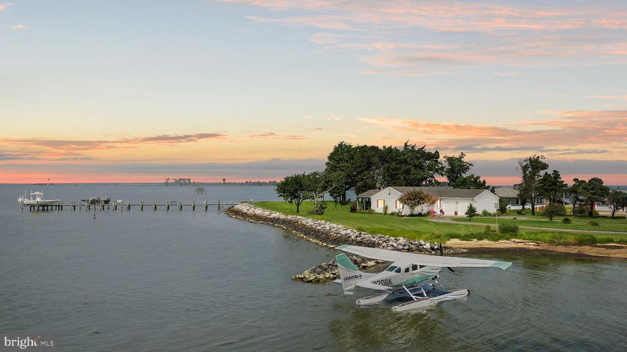 This is not just a waterfront property—it’s island living on the Chesapeake Bay, and it’s nearly impossible to find. With 800 feet of private shoreline, a 150-foot pier stretching into deep water with two boat lifts, electric, and water, and a rare private beach, this home delivers the ultimate coastal experience. Living on the Chesapeake Bay is incredible—but owning a property with its own beach is truly exceptional. Here, you can sink your toes into the sand just steps from your front door—or even land your own seaplane on the shoreline, as you can see in the listing photos—a luxury few will ever experience. Sitting on 2.38 acres at the tip of its own point of land, you get unmatched privacy, panoramic water views, and a level of seclusion rarely found.

For the sportsman, it’s unbeatable—private hunting blind, co licensed (with only one neighbor) 900 feet offshore for winter waterfowl season, and deep-water access for boating and fishing. The seawall and riprap are valued at approximately $750,000, and the pier at $250,000, giving this property exceptional built-in value before you even step inside.

The 3-bedroom, 2-bath home offers 1,650 square feet of bright, thoughtfully designed living space and is in excellent condition. The living room showcases breathtaking, panoramic views of the Chesapeake Bay and even has a wood-burning fireplace—perfect for a chilly fall or winter evening. Even the kitchen offers sweeping water views, making cooking a joy. The primary bedroom features its own private bathroom and direct bay views you can wake up to every morning. The floor plan is open and functional, perfect for everyday living and entertaining.

This is a true four-season home, designed to be enjoyed all year long—fishing in the summer, hunting in the winter, and soaking in sunsets no matter the season. The backyard is graced with beautiful shade trees, offering the perfect spot to hang a hammock, sip your favorite drink, and lose yourself in your next great book. A two-car garage, outdoor shower, and all furnishings included make this home completely move-in ready.

For investors, this property offers outstanding potential—projected at $75,000/year in short-term rental revenue with minimal upgrades, with management available at just 13% through Luke’s Vacation Rentals for an effortless income stream.

Opportunities like this are extraordinarily rare. Schedule your private tour today and see for yourself what makes this Chesapeake Bay retreat truly one-of-a-kind.