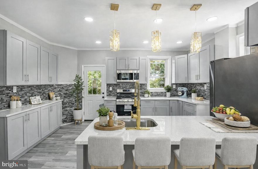 Welcome to 307 Poplar Street, where timeless elegance meets modern living. This fully renovated, move-in ready twin home has been thoughtfully reimagined with attention to every detail, offering a perfect combination of luxury finishes, smart technology, and functional design. Nestled on a quiet, tree-lined block, this 2-story gem boasts central air, a brand-new HVAC condenser, all-new electrical wiring, new vinyl siding, and a polished porcelain-tiled front porch that sets a stunning first impression. ✨ Main Level – Designed for Elegant Living. Step inside to a dramatic open-concept first floor, where rich textures and modern flair create an unforgettable atmosphere. The living room impresses with a floor-to-ceiling tiled accent wall, a stylish electric fireplace, and a grand chandelier that defines the space with warmth and sophistication. The flow continues seamlessly into the dining area and a chef-inspired kitchen featuring: Soft-close cabinetry and drawers. Samsung stainless steel appliances, including: Wi-Fi–enabled smart gas range with convection oven and built-in air fryer. French door refrigerator. Mounted microwave with exhaust fan. Sleek dishwasher. Brushed gold faucet and finishes for a bold designer touch. Just off the kitchen, step out to your private rear deck, overlooking a generously sized backyard — ideal for hosting, gardening, or simply enjoying the outdoors. 🛋️ Lower Level – Versatile Finished Basement. The fully finished basement offers a versatile extension of living space with a half bathroom, Samsung washer & dryer, new furnace, and new hot water heater. It's the perfect setting for a home office, guest suite, gym, or media room. 🛏️ Upper Level – Restful Bedrooms & Spa-Like Bath. Upstairs, discover three generously sized bedrooms, each featuring ceiling fans, ample light, and comfort. The beautifully updated full bathroom evokes spa serenity with floor-to-ceiling designer tile and a unique faux stained-glass window that fills the space with charm and natural light.