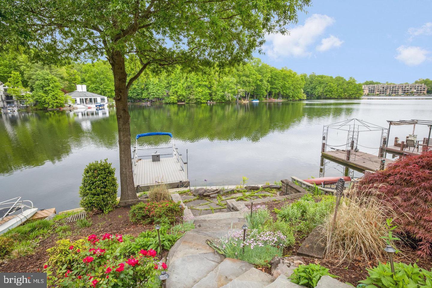 Rare opportunity to own a piece of waterfront End Unit Townhouse with large lake front views and private lake front with private dock boat and private front court yard. The main level offers hardwood floors, sunken living room with private side deck, balcony facing the lake, breakfast room, Renovated gourmet kitchen , wet bar and wine fridge, updated stainless steel appliances and dining area with sweeping views of Lake Thoreau and serenity abound. The upper level offers a large primary suite with views of the lake, updated primary bath and converted 3rd bedroom to large walk in closet. large 2nd bedroom and updated guest bath! The lower level offers an additional bedroom and full bath, huge recreation room and bump out with access to rear lower level deck, hot tub and gorgeous lake front! The tiered landscaping creates a dramatic entrance to the lower level lake private lake front with 3rd patio and private dock .