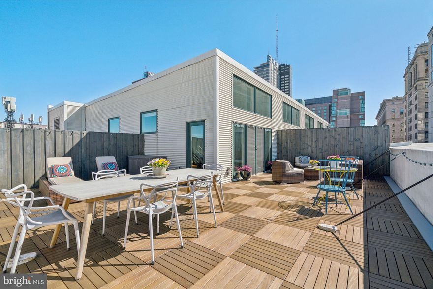 Experience a one-of-a-kind city residence in this expansive corner penthouse loft at 1228 Arch Street, Unit 8A. Spanning more than 2,200+ square feet, this distinctive home offers two spacious Primary Bedroom Suites, Three Bathrooms, and a generous Den that can easily function as a  3rd bedroom, Home Office, or Guest retreat. The main level welcomes you with an open-concept living, dining, and kitchen area highlighted by soaring 18-foot ceilings and dramatic two-story high windows that flood the space with natural light throughout the day. Authentic loft details including exposed wood and metal beams, original red brick walls, and rich warm wood flooring create an atmosphere that blends historic character with modern comfort. One of the home’s most exceptional features is the Private 730-square-foot Rooftop Deck, an incredibly rare outdoor space with sweeping skyline views that provide the perfect backdrop for relaxing mornings, sunset gatherings, or effortless entertaining above the city. The kitchen was thoughtfully designed for both daily living and hosting, featuring solid stone countertops, a 36-inch Wolf oven, Sub-Zero refrigerator, Bosch dishwasher, and a Viking beverage center with wine refrigerator. Also on the main level are a stylish Half Bath, a dedicated laundry room with full-size front-loading washer and dryer, a large walk-in storage closet, and a double-door coat closet. A bright corner bedroom with an ensuite bath and oversized walk-in closet completes this floor. Upstairs, the open den offers versatile living space before leading to the private top-floor primary suite, where a skylight above the soaking tub creates a spa-like setting alongside a walk-in shower, dual sinks, and natural stone finishes. Recent upgrades enhance the home’s appeal and provide a low-maintenance lifestyle, while condo fees that cover nearly All Utilities add exceptional value. Located just steps from Reading Terminal Market, Trader Joe’s, public transportation, and countless neighborhood dining and entertainment options, this home offers the perfect blend of scale, character, and convenience. With an acceptable offer, the seller is also including one year of prepaid Garage Parking located just half a block away. Schedule your private tour and see firsthand what makes this extraordinary condo truly unforgettable.  Enjoy the well regarded McCall School Catchment if needed, as well as, a low *4.99 %  mortgage interest rate offer for the first 12 payments at no cost to Buyer.*  OPEN HOUSE: SUNDAY, MARCH 15th from 12 P.M. to 1:30 PM