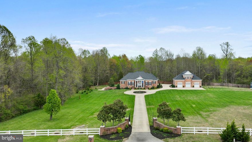 Experience the ultimate in privacy and elegance with this custom-designed estate, nestled on nearly 4 acres of serene land and accessed via a gated driveway. Boasting almost 7,000 sq ft of living space, this all-brick masterpiece offers the flexibility of up to 5 possible bedrooms and 3.5 bathrooms, designed with both comfort and style in mind.

As you enter, you’re welcomed by gleaming marble floors, soaring ceilings, and a spacious family room with a vaulted ceiling, hardwood floors, and a cozy wood-finished fireplace. Featuring extensive solid wood moldings and elegant chair rail detailing throughout, adding a timeless touch of craftsmanship and character to the interior spaces.  The custom kitchen is a chef’s dream, featuring tall cabinetry, striking granite countertops, and an oversized island perfect for entertaining.

Main level, you'll find three generously sized bedrooms, including a Jack & Jill bath with a ceramic-tiled walk-in shower. The luxurious owners  suite offers a vaulted ceiling, a large walk-in shower, and a custom walk-in closet with built-in shelving.

The lower level is an entertainer’s paradise, accessed by stunning custom cherry hardwood stairs and landing. Highlights include an expansive custom-built bar with rich cabinetry and sleek granite, newly stained concrete flooring, a dedicated theater room with a large projector and surround sound, a newly renovated bathroom with a walk-in rain shower, and two additional spacious rooms currently used as bedrooms.

Double doors open to a beautifully landscaped courtyard, allowing natural light to flood the lower level. The home is fully equipped with whole-house surround sound wiring, two laundry rooms (one on each level), and a custom wine room complete with a hidden safe room—perfect for wine enthusiasts and collectors.

Additional features include:

2-car attached garage with custom cabinetry and storage
3-car detached garage converted into a “man cave” with a finished upper-level office and its own HVAC system—ideal for an in-law suite conversion
A composite deck with vinyl fencing overlooking a private heated gunite pool recently converted to saltwater, complete with new cover and skimmer
Updated tiki bar and newly installed hot tub with cover
This home also comes with a host of recent upgrades:

Lifetime warranty CertainTeed Carriage House designer shingles
New concrete pads and sidewalks, garage door, window screens, and shutters
New appliances, septic pump, and updated electrical system
Prepped for a tankless water heater (with completed plumbing and electrical)
Permit filed for egress window in the lower level bedroom
Irrigation system installed around the landscaped grounds
All utility poles removed for a cleaner aesthetic
Custom flag pole added
No HOA and home warranty included
This exceptional estate blends high-end design, comfort, and functionality—all in a peaceful Southern Maryland setting. A truly unique opportunity for luxurious estate living.