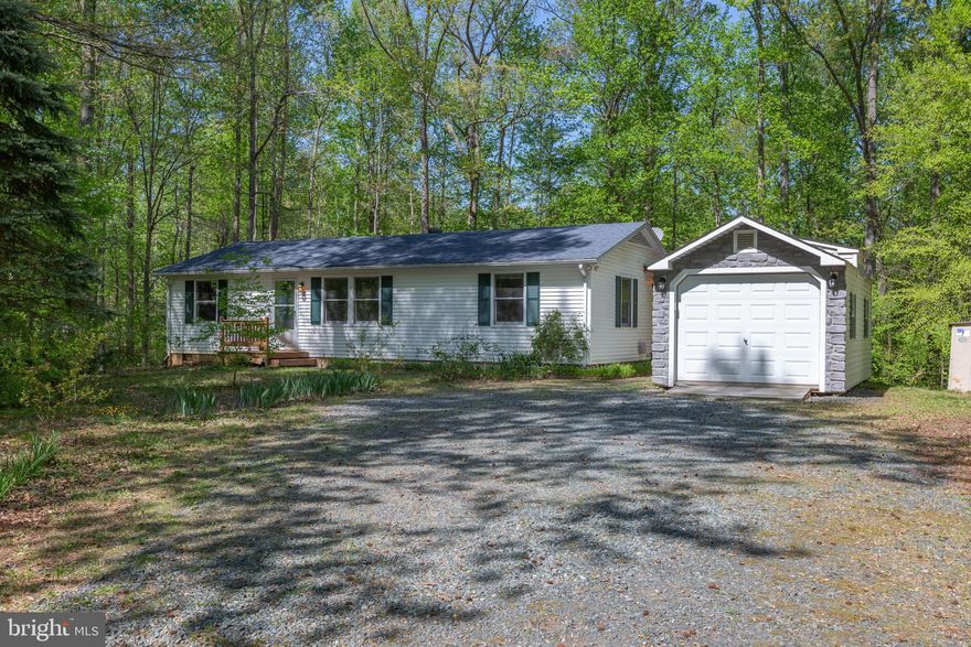 Enjoy the serene setting of this 3BR/2BA rambler nestled on a 1.63 acre partially wooded lot.  Listen to the birds sing, relax or entertain on the expansive wrap around deck and covered concrete patio  overlooking a spacious rear yard.   Inside, hardwood flooring greets you in the kitchen, dining & laundry room areas.  A well equipped kitchen comes complete with stainless appliances, plenty of cabinets and countertop space and opens to the living room and dining area. The primary bedroom features its own bathroom, double closet and ceiling fan.  Two additional bedrooms and  hall bathroom with  linen closet complete this perfect starter home!   An abundance of storage is provided by 3 sheds, one of which has electricity.  Park your vehicle in the one car detached garage offering an opener, remote control and extra space to tuck in belongings!  This gem is ready for your enjoyment and features a NEW TRANE HEAT PUMP (2022) and ARCHITECTURAL SHINGLE ROOF (2020).  The peace of country living is waiting for you!  Mountain View High School district.