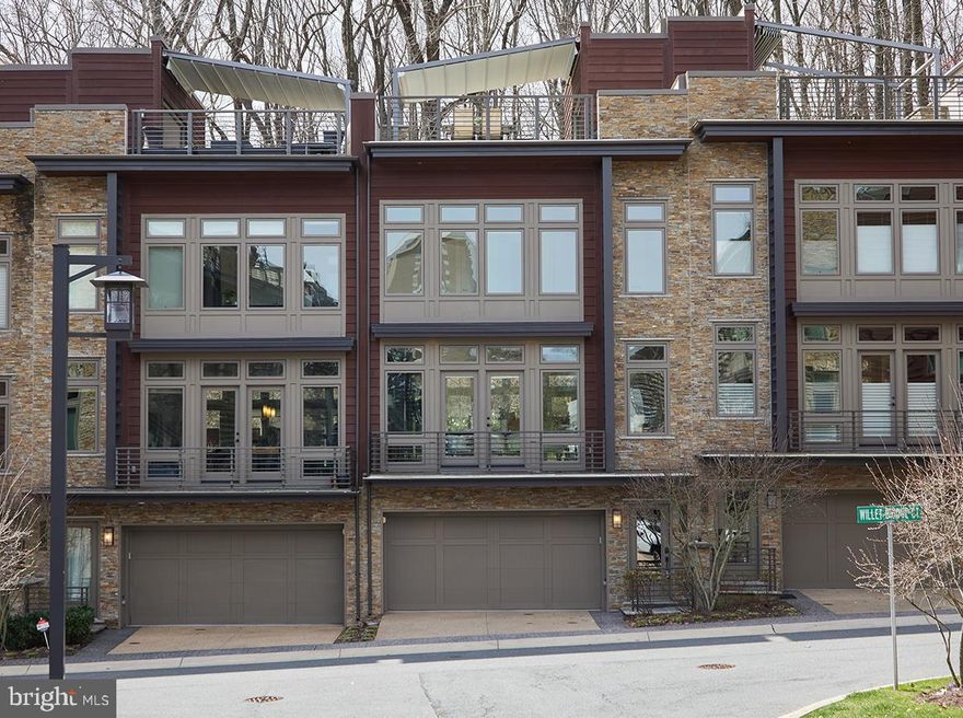 A rarely available courtyard Berkley Model (backing to woods!) ELEVATOR townhome in sought after Little Falls Place. One of just six homes in this location within a location nestled next to the Capital Crescent trail and moments to downtown Bethesda and more! <br>

As you enter the property either though the two car garage or the formal entry foyer, you are greeted by hardwood floors which continue throughout the entirety of the home. The entry level den functions as an ideal flex space (could be gym, could be office, could be an additional sleeping area..) and benefits from a large powder room. The ELEVATOR can be accessed here to reach all four floors of the property making this truly an accessible home for anyone! <br>

The open concept second floor (main living area) features a fabulous chefs kitchen with a large granite island, high end cabinetry, and a Thermador and SubZero appliance suite with gas cooking. Dual living/family areas benefit from a powder room as well as both a balcony and a fully fenced patio situated amongst the trees, creating gorgeous and seamless indoor and outdoor living!! <br>

The third floor (bedroom level) features two generously sized guest rooms as well as a beautiful hall bath and the huge primary suite. The primary overlooks the tranquil woods creating a serene setting and immense privacy, and features a true spa like bath with dual vanity, heated floors, and custom lighting. <br>

But that’s not the end of the tour on this one.. The fourth (rooftop) level is a dream with a fully functioning outdoor kitchen (Viking appliances), rooftop television, an outdoor gas fireplace, and a covered seating area with a retractable awning - creating a space that can be enjoyed in several seasons (and making you the entertaining envy of all your friends!!). <br>

All this in a private secluded enclave that is walkable to Whole Foods, nearly on top of the Capital Crescent Trail, mere moments to Downtown Bethesda, and with the easiest of access to major city and regional arteries (Mass Ave, 495, etc..) that this is a commuters dream location! Guest parking available within the community and additional driveway space in front of your own garage also makes having guests over a breeze! Come see today why this is truly the best of Bethesda Townhome living!