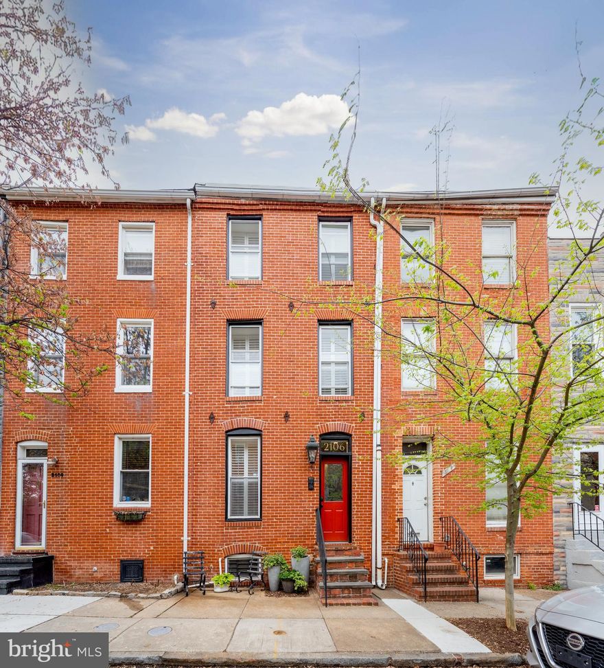 Welcome to 2106 E Lombard Street—where urban energy meets elevated design in one of Baltimore’s most desirable and walkable neighborhoods. Situated just blocks from Johns Hopkins Hospital, Patterson Park, and the Fells Point waterfront, this meticulously updated rowhome combines historic charm with modern comforts across four thoughtfully designed levels.

Step inside and feel instantly at home. Exposed brick, original hardwoods, curated color palettes, and custom lighting create a space that’s equal parts stylish and soulful. The main level flows seamlessly from the living room—with built-in shelving and a working fireplace—to a sun-drenched dining area with exposed brick, and into a fully upgraded kitchen featuring emerald green cabinetry, granite countertops, and stainless appliances.

Upstairs, the spacious third floor primary suite includes a walk-in closet, exposed brick chimney detail, and a renovated bath with designer tile and abundant natural light. The second level bedroom is equally inviting and offers flexible living—perfect for a home office, guest retreat, or cozy den. Dreaming of a roof top deck? The second floor is access ready. The basement provides even more usable space with excellent storage and systems.

Outside, your newly redesigned rear patio is a private city oasis with flagstone hardscaping, mature plantings, and ambient lighting. Beyond that, the private parking pad is a rare Butcher’s Hill luxury—no more circling the block!

Surround yourself with the charm and convenience that make Butcher’s Hill a true urban gem. Just a short stroll from your doorstep, you’ll find beloved local spots like Greedy Reads for your next great book, get in the best shape of your life at Pilates House, go zen at Sedona House, and for a cozy coffee or quick bite visit Charmed Café. Enjoy brunch at Marta, classic corner vibes at Peter’s Inn, and gelato perfection at Pitango—all just blocks away. Whether you are craving community, culture, or just a great cup of coffee, this neighborhood delivers on every level.