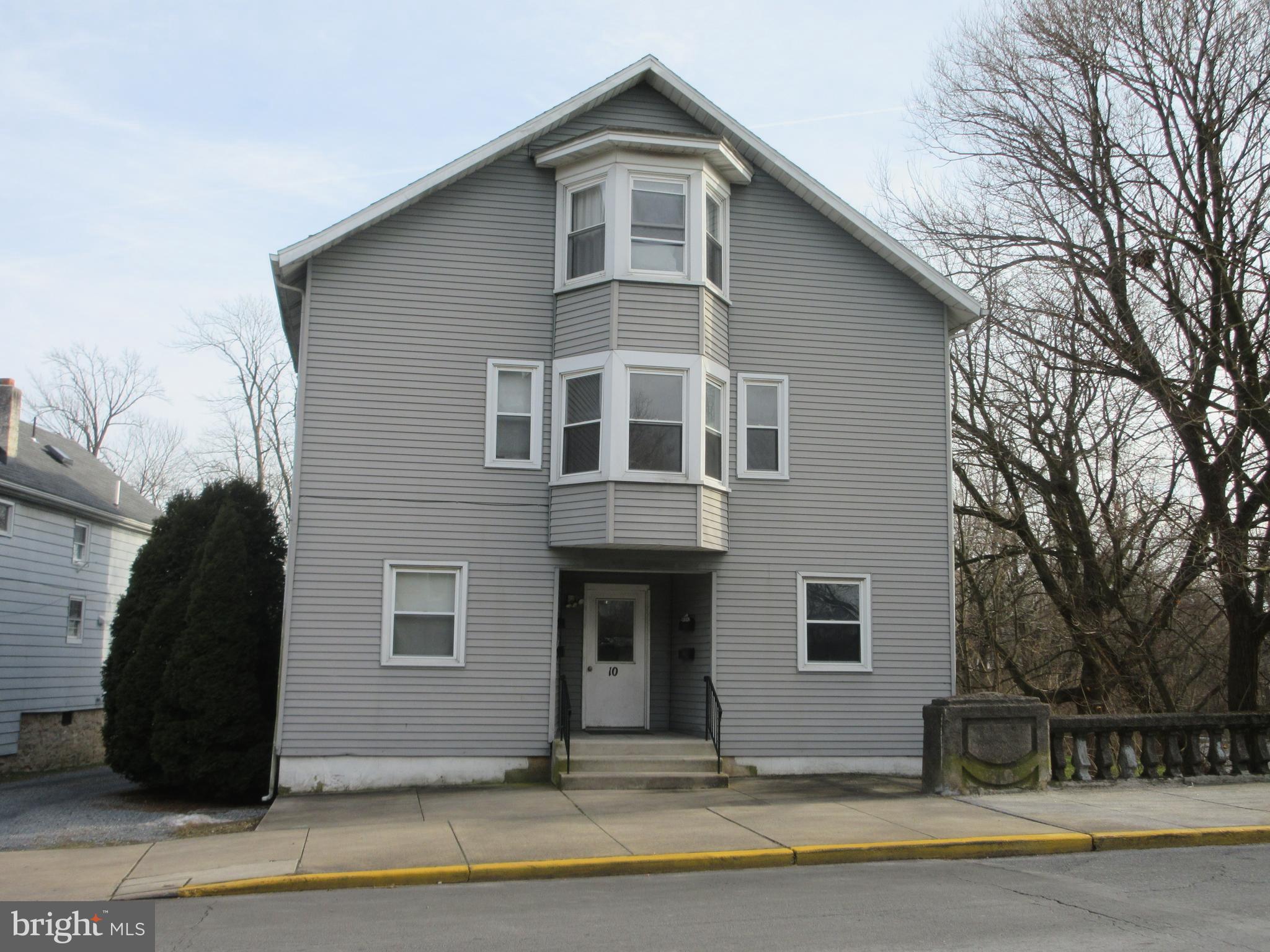 KUTZTOWN STUDENT HOUSING - Incredible opportunity to purchase a well maintained 4 unit building just minutes from Kutztown University. 7.14% Cap Rate. 12.21% Cash on Cash Return. Property consists of four apartments licensed for 11 students with 11 individual bedrooms, common area, laundry room, off street parking for 13 cars and 3 oversized garage bays. All apartments have one full bath. 0ne 2 student apartment and three 3 student apartments. Landlord pays water, hot water, sewer, taxes, insurance, basement and laundry area electric. Tenants pay for electric, trash, cable and internet (all apartments are electric baseboard heat). 5 meters, one for each unit plus landlord meter. New improvements include new vinyl siding on building (2024) and new roofs on building and two garages(2024) water heater (2019)and $58k addition of two bedrooms to unit 4 apartment to increase total student permit from 9 to 11 bedrooms (2013). All appliances are included in the sale. Centrally located next to Turkey Hill and within walking distance to downtown dining & shopping. Great rental history. Additional rent from summer occupancy and garage rental.