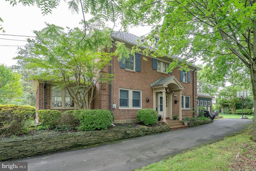 Welcome to this classic center-hall Georgian Colonial that seamlessly blends warmth, elegance, and quality craftsmanship. Set on a picturesque, tree-lined street, the stately brick exterior and thoughtful architectural details offer unbeatable curb appeal.
Inside, this 4-bedroom, 2.5-bathroom home boasts stunning hardwood floors with rich mahogany inlay and a gracious center-hall layout. To the left of the foyer, the spacious living room features a cozy wood-burning fireplace flanked by built-in bookcases—perfect for relaxing or entertaining. Adjacent to the living room is a bright and inviting sunroom, ideal for morning coffee or quiet evenings.
To the right of the foyer, the formal dining room offers an elegant space for holiday gatherings or dinner parties. At the heart of the home is a gourmet kitchen, meticulously designed with crisp white cabinetry, granite countertops, a 6-burner cooktop, wall oven, tiled backsplash, hardwood floors, and a beautiful copper-topped island. An adjoining office nook/butlers pantry/laundry room and first-floor powder room add both function and style.
The second floor features three generously sized bedrooms, including a primary suite with a  renovated ensuite bath. A second full bath and two additional bedrooms complete this level. The third floor offers a versatile loft-style fourth bedroom—perfect as a guest suite, playroom, or creative retreat.
Additional features include a spacious, partially finished basement with a half bath, a lovely perennial garden, a large backyard, and driveway parking. Whether you're cozying up by the fireplace or enjoying the outdoor space, this home offers a perfect blend of comfort and charm in a sought-after neighborhood. Close to everything you can possibly need ! Close to nearby train station and nearby shops and restaurants.  Quick commute to Center City,  Turnpike, 309, 476 and I95.