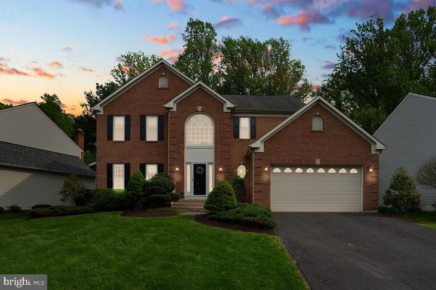 Exquisite colonial with stunning flat lot tucked away on a quiet street that ends in a cul-de-sac! The curb appeal welcomes you in, and the designer details will make you never want to leave. Gleaming hardwood floors carry throughout the main level. Gourmet kitchen with custom tile and high-end stainless appliances opens to the family room with brick fireplace and wood beam details on the ceiling. Formal living room with built ins makes the perfect library or potential home office! Grand master bedroom with vaulted ceilings is truly an owner's retreat, complete with spacious en-suite with separate vanities, large tub, and walk-in shower, and walk-in closet. Gorgeous level lot will keep you outside all summer long. Spacious deck, brick paver patio, and meticulously maintained landscaping, this home has everything you have been waiting for!