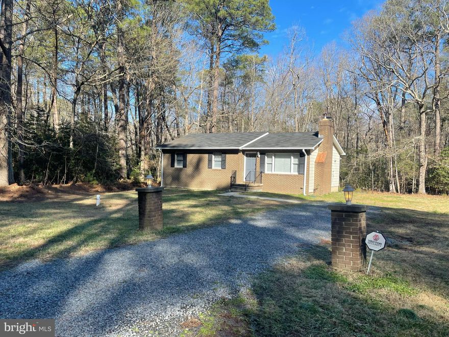 This one level, three bedroom, two bathroom home boasts hardwood floors in main living area, carpeted bedrooms, updated bathrooms and tile in kitchen  and sun porch.  Kitchen has updated stainless appliances and granite countertops.  Freshly painted throughout. Full sized washer and dryer.  Huge lot with a large shed with work bench. Water privileged community with boat ramp and beach use.  Home is dog friendly and no extra pet fee monthly!  Set up a time to come tour this great home.