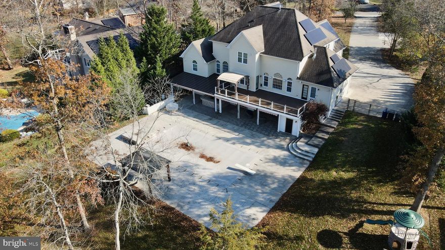 Welcome to 21490 Cedar Dr, an exquisite custom-built brick colonial in the prestigious Richland Acres neighborhood of Sterling, VA. This home sits on a picturesque 1.03-acre lot and offers 7 bedrooms, 5.5 bathrooms, and over 5,200 square feet of meticulously upgraded living space that marries elegance with modern functionality. The owners have completely updated the entire home.

You’ll notice the rich, new hardwood flooring that extends throughout the home, complemented by fresh wainscoting and all-new window treatments. The level has been opened up for a more open floor plan. The expansive main level includes a formal dining room, an updated kitchen with new cabinetry, a large pantry, and a suite of modern appliances. The kitchen opens to a two-story family room featuring a new gas fireplace and custom built-ins, perfect for cozy evenings or entertaining guests.

The main level primary suite is a true retreat, showcasing an updated primary bedroom suite with two spacious walk-in closets. The luxurious primary bathroom includes heated floors for added comfort. Additional upgrades include the installation of a trayed ceiling.

The upper level offers four additional bedrooms with new carpeting, and the lower level provides a full in-law/au-pair suite with a private kitchenette, bedroom, office space, and new carpeting. This level is ideal for multigenerational living, providing both privacy and convenience.

Step outside to your private oasis, complete with an in-ground heated saltwater pool, a pool house with a half-bath, and a surrounding patio for summer gatherings. A whole-home generator, central vacuum system, and solar panels elevate the home’s functionality and efficiency. Recent updates include HVACs in 2017, additional spray insulation for enhanced energy efficiency, and updated window treatments throughout.

With a three-car garage, ample outdoor living spaces, and a prime location near top-rated schools, 21490 Cedar Dr is a rare find—a home where luxury, comfort, and sustainability meet. Don’t miss this unique opportunity to experience high-end living in a setting that’s as beautiful as it is functional.