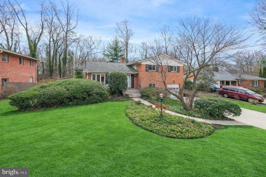 Welcome to 9804 Inglemere Drive, an updated split-level home tucked away on a quiet street in Bethesda’s desirable Fernwood neighborhood. Built by Stearman & Kaplan, this Berkley model offers 2,898 total square feet with 5 bedrooms, 2 full baths, and a powder room. The home was refreshed in 2026 with fresh paint throughout, refinished hardwood floors, and new carpet. Set on an oversized 0.34-acre lot, it features a fully fenced backyard with a side porch off the kitchen, a large rear patio, level green space, and professional landscaping—ideal for relaxing or entertaining. Inside, a slate-tiled foyer opens to sun-filled living spaces framed by floor-to-ceiling windows. Refinished hardwood floors extend throughout the main and upper levels. The spacious kitchen offers Corian countertops, recessed lighting, an island peninsula with a cooktop, a built-in desk, and abundant white cabinetry. It provides plenty of opportunity to redesign and personalize over time, while also functioning comfortably as is. The kitchen flows seamlessly into the dining and living areas, and a door provides convenient access to the porch and backyard. Hardwood floors continue up the staircase and throughout the upper level, creating a warm and cohesive feel. The primary suite includes a walk-in closet and a private bath with a walk-in shower. Three additional bedrooms and a full hall bath complete this level. The lower level, which is fully above grade, features a light-filled family room with new carpet, a wood-burning fireplace with a rustic brick surround, and sliding glass doors opening to the patio and backyard. This level also includes a flexible fifth bedroom or office, a powder room, and access to the garage. One level below, the basement offers additional flex space with engineered wood flooring, ideal for a home gym, media room, workshop, or extra storage. Ideally located near shopping, dining, entertainment, and major commuter routes, the home also offers easy access to parks, recreation facilities, and several nationally rated golf courses. Top-rated Montgomery County schools complete the package.
Don’t miss this opportunity to own a wonderful home in one of the DC area’s most sought-after communities.