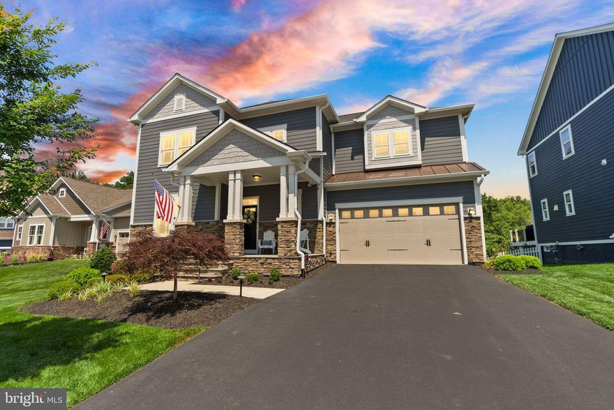 Exceptional 5-Bedroom, 5.5-Bath Luxury Home in Sought-After Willowsford – Private Cul-de-Sac Location Backing to Trees

Welcome to this exquisite residence located in the heart of the award-winning Willowsford community, perfectly nestled on a quiet cul-de-sac and backing to a tranquil tree line for added privacy. This beautifully designed 5-bedroom, 5.5-bath home offers over 5,000 square feet of refined living space and showcases high-end finishes and thoughtful upgrades throughout.

Step inside to find an open-concept main level with rich hardwood flooring throughout the primary living areas. The gourmet kitchen opens to a bright and inviting family room and features a beautifully finished custom walk-in pantry for abundant storage. Just off the kitchen, the butler’s pantry includes a wine fridge and custom pantry. The morning room bump-out is ideal for entertaining guests in style. A unique feature of the home is the main level guest suite bedroom with full bathroom. Elegant plantation shutters, detailed millwork, wallpaper and designer lighting add sophistication and warmth throughout the home.

Upstairs, the expansive primary suite offers a peaceful retreat with a sitting room, complete with a fully customized walk-in closet and a spa-like en suite bathroom. Three additional bedrooms upstairs with two bathrooms including elevated tile finishes, along with walk-in closets. The laundry room is also on this level with built in cabinetry and full sink. 

The walkout lower level offers flexible space with potential for a sixth bedroom, a wet bar rough-in, and built-in indoor/outdoor speakers for immersive entertainment.

Enjoy seamless indoor-outdoor living with a stunning screened-in porch, perfect for relaxing year-round while taking in the private wooded views. The professionally landscaped backyard features uplighting, a stone paver patio, and a fully equipped outdoor kitchen with a refrigerator and a gas line ready for your grill. A charming stone front porch adds to the home’s timeless curb appeal.

Additional highlights include an automated irrigation system, energy-efficient tankless water heater, professionally installed radon mitigation system, 220 amp electrical outlet ready for a hot tub, and a comprehensive security system with cameras for peace of mind. Smart home upgrades such as a Nest thermostat with an upstairs sensor make everyday living easier. To top it all off, a brand-new roof was installed in 2024.

Set within the vibrant and amenity-rich Willowsford community—offering pools, trails, a community farm, and events—this home combines elegance, functionality, and the best of modern living.