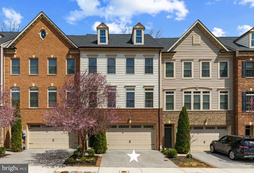 Set in one of Hawthorne’s Grant’s most desirable and private locations, this luxury colonial townhome backs to peaceful wooded views and protected green space. Meticulously maintained and thoughtfully upgraded, this exceptional 3-bedroom, 2.5-bath residence offers beautifully finished living spaces across three levels. The open-concept main level is designed for both everyday living and elevated entertaining, featuring rich hardwood floors, recessed and designer lighting, and a stunning chef’s kitchen anchored by an impressive 13-foot quartz island. Highlights include a 5-burner gas cooktop with vent hood, wall oven and built-in microwave, double sink, and a striking tile backsplash that extends to the ceiling, a rare and sophisticated detail. The adjoining dining area is complemented by a well-appointed butler’s pantry with beverage center, wine cooler, and additional cabinetry, along with a walk-in pantry and a discreet powder room. The spacious family room offers built-in surround sound, ceiling speakers, and an upgraded gas fireplace, with two sets of French doors that seamlessly connect indoor and outdoor living. Step onto the maintenance-free composite deck overlooking expansive manicured green space and protected wooded surroundings that can never be developed, offering a rare sense of privacy, perfect for entertaining or relaxing. Upstairs, the serene primary suite features two generous walk-in closets, including a custom-designed closet, and a spa-inspired en-suite bath with dual vanities, a glass-enclosed tiled shower, and a private water closet. Two additional bedrooms, a full hall bath with dual vanity and shower/tub combination, and a convenient upper-level laundry room complete this level. The light-filled lower level offers exceptional flexibility with a spacious recreation room ideal for a second family room, guest space, office, or gym. High ceilings, recessed lighting, and side windows enhance the space, while a patio door leads to a covered stone patio. This inviting outdoor space provides a true extension of the home, ideal for relaxing, dining, or entertaining while enjoying the peaceful, private natural surroundings. A large storage room is already roughed in for a future bathroom, and three oversized closets provide abundant storage. The two-car garage includes drop-down storage systems. Enjoy a peaceful, private setting just minutes from shopping, dining, major commuter routes, downtown Annapolis, and BWI Airport, and within close proximity to Blue Ribbon Arnold Elementary. A rare opportunity to own a truly turnkey, luxury townhome in an unbeatable location.