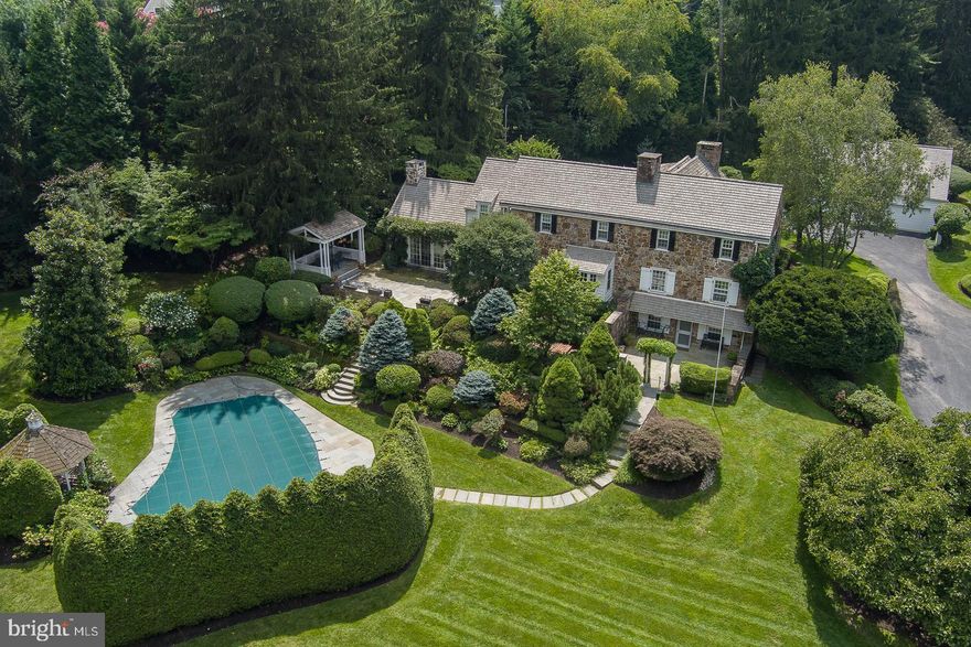 Welcome to 1411 Youngs Ford Road. This classic stone and clapboard home set on a private 1.9-acre lot in Gladwyne, seamlessly integrates a classic design with recent renovations to accommodate today's lifestyle. The beautiful center hall entrance with a brick and tile floor runs the length of the house.
The formal living room has an abundance of natural light, along with the connecting den provide beautiful views overlooking the terrace and landscaped yard. The formal dining room features an oversized fireplace as the focal point of the room, accompanied by an adjoining pantry. The rear entrance provides direct access to the kitchen and great room, and onto the upper terrace. The partially finished lower level features a fireplace and direct access to the lower terrace. The second floor features an impressive main suite with views and plentiful closet space. The two other bedrooms each have their own baths and additional office/study space. The fourth bedroom, ensuite on the first floor. The privacy of the site is highlighted by extensive landscaping, beautiful flagstone terrace and in-ground pool, creating your own private oasis. The expansive three-car detached garage, along with plenty of parking assist in entertainment. Conveniently located with easy access to all major roads, Philadelphia airport and train stations.
Come see this classic gem of a home.