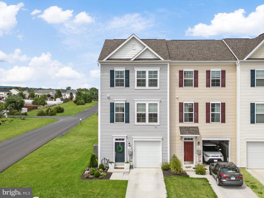 NEW LISTING PRICE for this Charming End Unit Townhome with Modern Upgrades in Prime Location!

Welcome to this stunning end unit townhome with a 4' extension on all 3 floors that adds extra living space and lovingly maintained by its original owner. Featuring 3 bedrooms, 2.5 baths, and 9' ceilings, this home offers an inviting and spacious ambiance. The main level boasts luxury vinyl flooring throughout, and the gourmet kitchen is a chef's dream with quartz countertops, pendant lighting, a stylish backsplash, pantry, reverse osmosis water filter, and a cozy breakfast nook and enjoy meals in the additional dining area with sliding glass doors that lead to a maintenance-free deck, perfect for outdoor entertaining.

The expansive living room and convenient half bath complete the main floor. Upstairs, the primary suite is a serene retreat with a walk-in closet and a luxurious bath featuring a soaking tub, separate shower, and dual sinks. Two additional well-sized bedrooms share a hall bath with a tub/shower combo.  Laundry area with washer, dryer and extra shelving located on the bedroom level for added convenience.

The basement, filled with natural light from full windows and a walk-out door, is ready to be finished to your specifications and includes a rough-in for a future bath. The large, level backyard backs to a common area, providing a peaceful outdoor space.

An oversized garage offers ample storage and parking. Located just minutes from I-81 and close to Winchester, VA, this home combines convenience with modern living. Don't miss out on this fantastic opportunity!