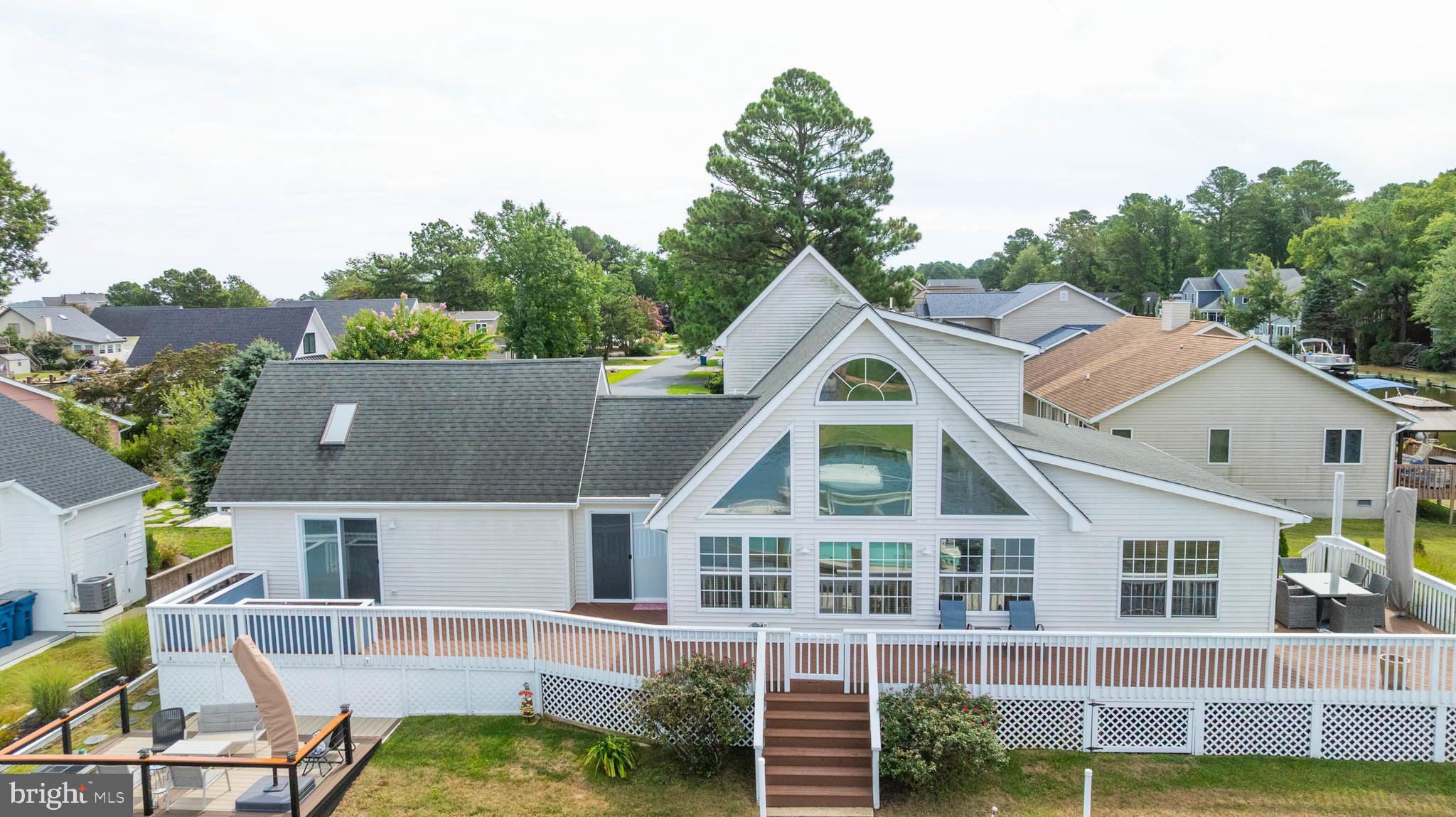 Experience waterfront living at its finest in this beautifully maintained coastal-style home, perfectly situated along a bulkheaded canal with serene water views. This 3-bedroom, 2.5-bath retreat features a sought-after main-floor owner’s suite and a recently renovated kitchen with stylish finishes, ideal for both everyday living and entertaining. Floor to ceiling windows in the living room to enjoy the peaceful water view. Enjoy seamless indoor-outdoor living with a spacious wraparound deck—perfect for relaxing, dining, or taking in the tranquil canal setting. A true blend of comfort and coastal charm, this home is ready for your next chapter on the water.