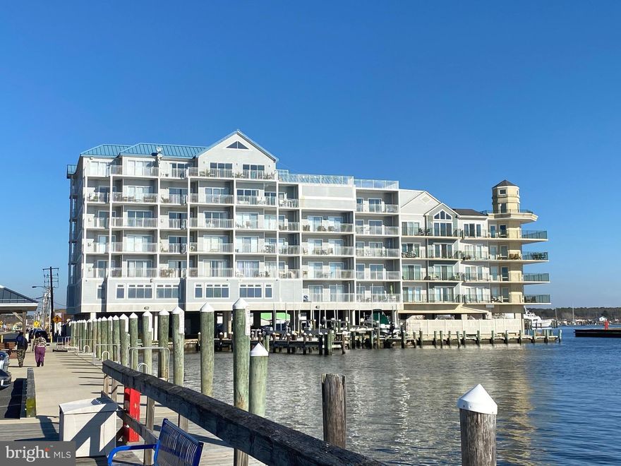 Welcome to your waterfront Oasis! This spacious 2 bedroom, 2 bathroom condo in rarely available Captain's Galley offers everything you expect of coastal living and more! Your interior offers nearly 1,500 finished square feet chock full of amenities. As you walk through the front door and down the hallway, you are greeted by a beautiful kitchen with wood cabinetry, stainless steel appliances, and timeless granite countertops that flow into a breakfast bar. Off the kitchen is a separate dining area with ample table space and a wet bar with a mini fridge and wine cooler tucked adjacent to a spacious living room with balcony access for unobstructed waterfront views and a propane burning fireplace.  Bedroom #2 is off the living room with a separate entrance to a centrally located full bath. Your primary bedroom is tucked away from the action and offers its own full bath with a soaking tub AND standalone shower! Your west-facing unit offers absolutely stunning views of the sunset, Crisfield city dock, Somers Cove, and a prime observatory for the famous boat docking contest every Labor Day weekend. Common area amenities include a rooftop sunning deck and swimming pool, exercise room, assigned parking, and more! Call your agent and schedule your private showing today!