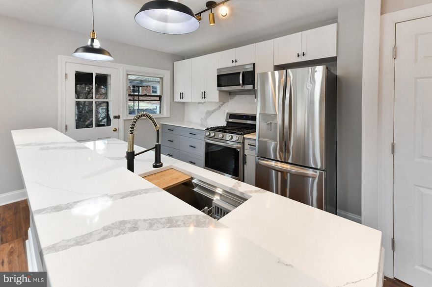 Another high end renovation by the Emvestments Home Group. This fully renovated large corner property is equipped with hardwood floors and contemporary accents throughout will take your breath away. From the elegant sconce lighting in the living room to the stylishly coordinating pendant lighting in the kitchen, this home does not lack ONE ounce of comfort and charm. The floorplan includes ample living room space which flows effortlessly from the private covered front porch and rear deck. Prep your dinner and libations leveraging your customized workstation, nestled within the kitchen island with sprawling quartz countertops. Bring out your inner chef in this gorgeous kitchen, furnished with high-end LG appliances all perfectly coordinated against your quartz back-splash. When its time to entertain, the spacious industrial designed finished basement is quite the transition. The basement offers the perfect family room, full bathroom, a separate entrance conveniently located outside of your driveway and private garage. 

Welcome Home!