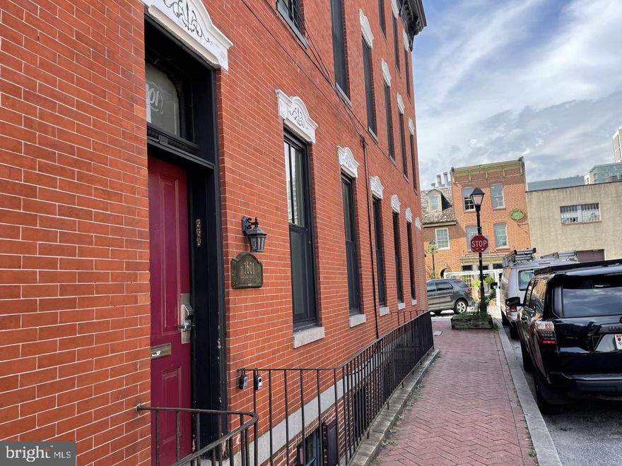 Bright & stylish 1-bedroom and 1-bathroom Fells Point townhouse on historic cobblestone street, less than 2 blocks from the waterfront. First floor unit is accessed from common entrance and apartment has a second entrance on the 2nd level. Unit has two floors, living room/kitchen on first floor, spiral staircase to upstairs one bedroom and bathroom. High ceilings and large windows in bays, wood flooring. Open kitchen/living area with gas range. Common coin laundry in building. Recessed lighting and ceiling fans. Unit has two split HVAC systems for comfort and energy efficiency. Common rear patio is adjacent to unit. Pet Policy: Cats only with a $200 non-refundable pet fee.