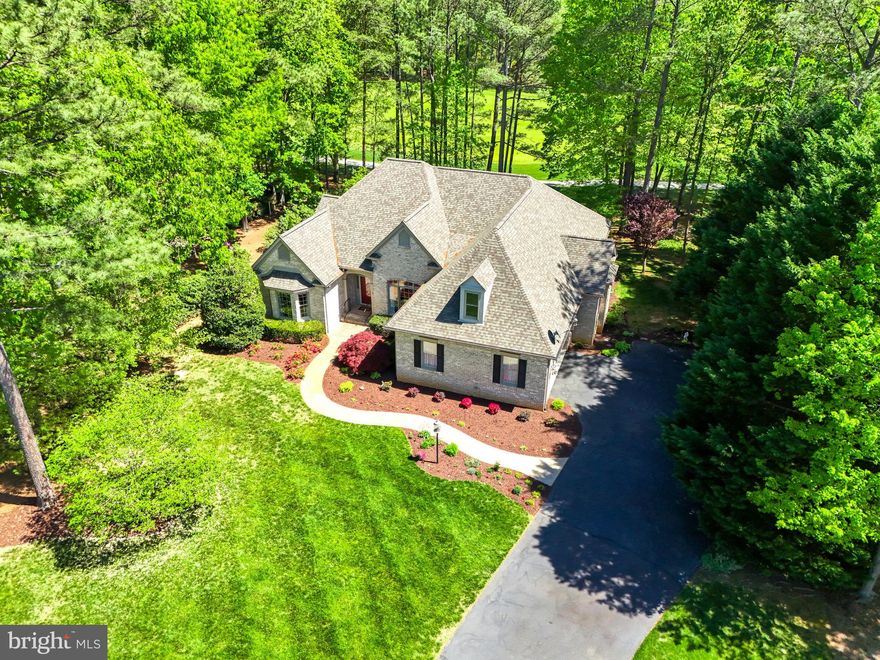 Gorgeous turn-key custom Dream Home sited on a beautiful lot overlooking the majestic Fairway of the Fawn Lake golf course inside the luxury community of Fawn Lake. Designed for casual main level living, this charming brick home offers a semi-open floor plan filled with timeless architectural details at every turn! 
A beautiful welcoming Parlor with Marble floors ​is anchored by an elegant  Dining Room with soaring trey ceilings and large Palladium windows. On the opposite side an inviting formal Living Room invites you to gather and entertain. Sitting at the center of the home is a ​stunning Family Room with a ​gas fireplace ​flanked by custom built-in bookcases and media cabinetry. French Doors lead​ to a spacious deck and the idyllic stone patio, offering extended living and entertaining opportunities while overlooking the backyard, and golf course just beyond. The gourmet Kitchen with cherry cabinets, stainless steel appliances ​and granite counters, features a charming sunlight Breakfast ​nook with large windows that provide tranquil views of nature.  The gracious Main Level Owner's Suite with lighted tray ceilings features a large walk-in closet and a luxurious Spa Bath with soaking tub, tile shower and ​ a huge vanity with dual sinks.  Two additional spacious bedrooms with walk-in closets are anchored by a ​beautiful Full Jack-n-Jill Bath.  A Convenient Laundry Room with ​utility sink and ​cabinetry, ​along with a charming Powder Room completes the Main Level.
Complete with plumbing rough-ins, the large unfinished basement provides plenty of storage and space for future  expansion. Meticulously maintained, the home features a New Roof ​installed in 2019, along with new gutters. The new energy efficient HVAC was installed in 2022.  The Trex Deck was installed in 2022. 
The ​beautifully landscaped grounds are easily maintained with the in​-ground irrigation system​ installed on the property.​ Custom built by renowned Sagun Homes, this charming home is perfectly nestled on a quiet street on a beautiful .60 acres surrounded by mature hardwood and blooming trees providing wonderful views of nature and privacy! Located ​in a desirable established area, right in the heart of ​Fawn Lake! Conveniently located steps away to the walking and biking path that leads to the pool, beach, tennis courts, and the Fawn Lake Country Club! The beautiful Luxury Fawn Lake Community offers amazing amenities such as a boating recreational lake, beach, Arnold Palmer designed golf course, tennis courts, baseball and soccer fields, dog park, volleyball courts, walking trails, Community ClubHouse, marina, fitness center, restaurants, Country Club, playgrounds, and so much more! Located in the countryside near the town of Fredericksburg, surrounded by park lands and only a few miles to the farm market, wineries, and award winning breweries!