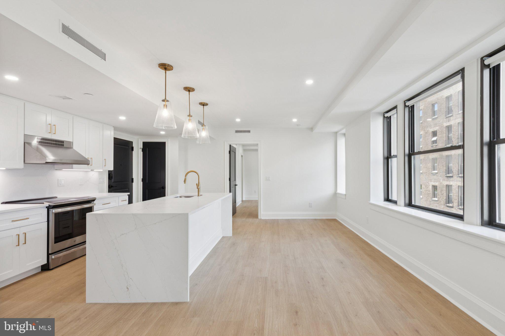 Brand new two bedroom, two bathroom with sunset city views and modern finishes at The Wellington on Rittenhouse Square! This new construction home features an expansive great room with oversized windows and an open layout, perfect everyday living and entertaining; a sleek open kitchen with white shaker cabinetry, quartz countertops and backsplash, GE stainless steel appliances, and a center island with breakfast bar and waterfall countertop; a spacious primary suite with a wall of oversized windows, large walk-in closet, and an ensuite bathroom with a modern white vanity, glass-enclosed shower, and calacatta tilework; a generously sized second bedroom with large wall closet; full hall bathroom appointed in calacatta tilework with sleek vanity and glass-enclosed shower; stacked LG washer/dryer; and recessed lighting, excellent closet space, and vinyl floors throughout. This home also enjoys individual heat & air conditioning controls. The Wellington is a pre-war apartment building located on Rittenhouse Square offering a 24 hour doorman, on-site management, and access to a nearby fitness center at 1845 Walnut. Tenants are responsible for paying all utilities.
