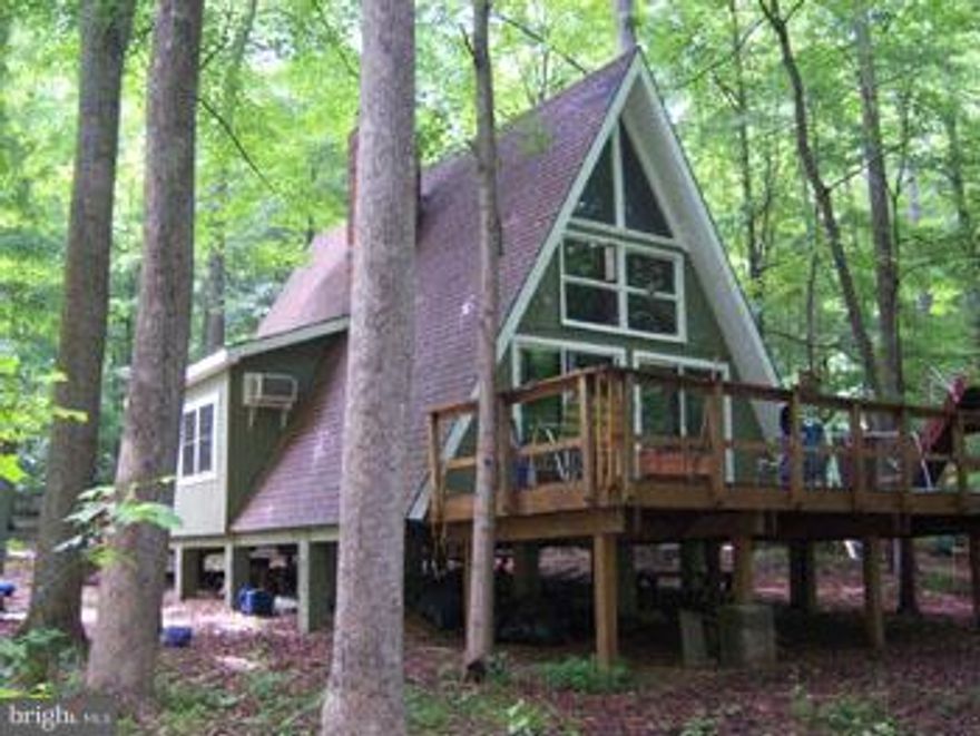 Lazy Days Await You, Comfortable vacation cabin just a short distance from the Cacapon River and river access lot. New windows, recent roof replacement & cabinets,  Pine ceilings with exposed beams, Fireplace and wood stove. Nice lot with mature trees for added privacy. Come out for a look today!