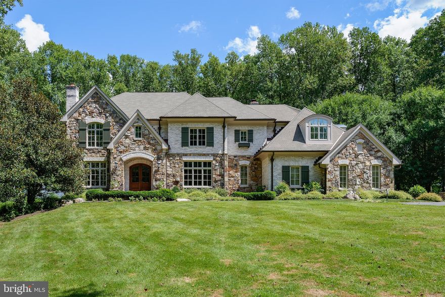REDUCED!  Gorgeous custom home on 5.5 acres of tranquility! Virtual utube video:    Custom  Fieldstone and hand made Brick, Architectural Roof, Copper Gutters,  exterior  leads to Mature trees surround premises plus around the private swimming pool and hot tub, which leads you to your cabana with curved copper hip roof plus  hot tub and fieldstone fireplace, all for perfect entertaining!   Entertainers delight with outdoor built in kitchen , bath and dressing room and hot tub  for total relaxation.  Walk in to the Grand foyer with a nearby  Grand Curved Staircase.  Formal living room with fireplace and  Library  will greet your guests.  The open floor plan  includes  large gourmet kitchen with island  and stainless appliances ( 2 ovens, 2 dishwashers, wine refrig) , formal dining room,  large family room with fireplace and nicely appointed  built ins.  Family room leads to the Solarium/ Music Room and large deck overlooking swimming pool,  trees and perfectly landscaped yard. Dual Staircases lead Upstairs to Master Suite and two sets of Jack and Jills /Bonus Rm.   Lower level has additional bedroom and full bath with additional family room and bonus rooms for entertaining, then, walk out to the pool and cabana.  In addition to the 3 built in garage spaces, enjoy additional parking for cars, work space, cycles in the detached Carriage House!  Close to Tysons, and Great Falls Village!  Great Value!