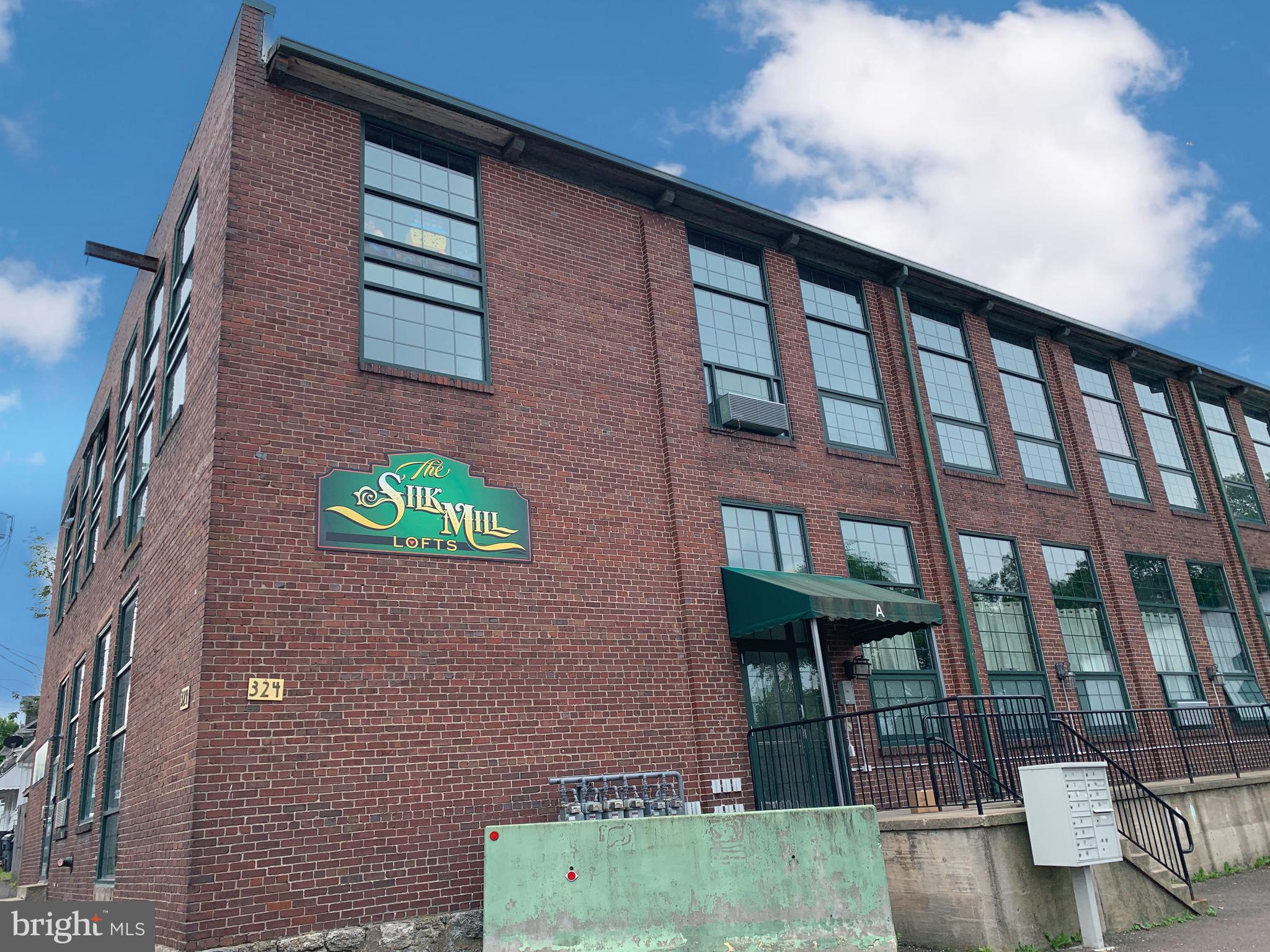Here's your second chance! Buyer changed their mind days before settlement!! Wow, take a look at this one of a kind, rarely available, NY style Silk Mill Loft condo! Original exposed brick with sprawling open concept 2BR, 2BA. Main floor has kitchen/living room with gas fireplace and ample space for entertaining. 2nd floor has spacious Master BR, Master bath, with laundry, and additional BR and full bath. Large parking lot for secure off street parking. Schedule your showing today!!!