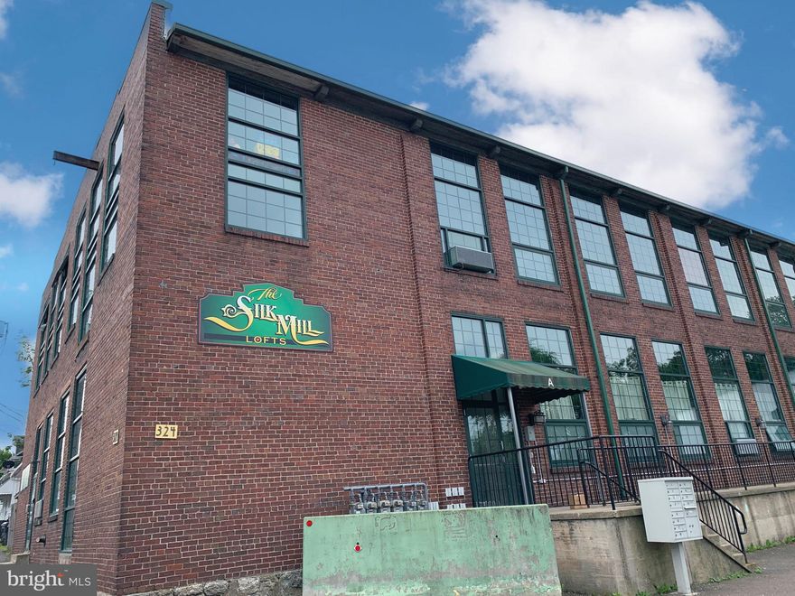 Here's your second chance! Buyer changed their mind days before settlement!! Wow, take a look at this one of a kind, rarely available, NY style Silk Mill Loft condo! Original exposed brick with sprawling open concept 2BR, 2BA.  Main floor has kitchen/living room with gas fireplace and ample space for entertaining. 2nd floor has spacious Master BR, Master bath, with laundry, and additional BR and full bath.  Large parking lot for secure off street parking. Schedule your showing today!!!