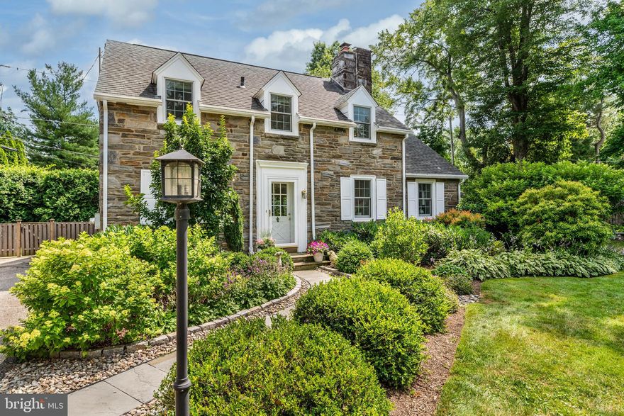 A rare find, this exquisite 1930s stone carriage house on a .28 acre level lot has been completely renovated by the current owner, maintaining its historic charm while modernizing key operations for today’s discriminating Buyer. The result is an elegant, turnkey home with low-cost maintenance and energy efficiency that will appeal to many. 
Enter this gracious home via a cobblestone-lined walkway flanked by boxwoods and limelight hydrangeas. 
Upon entering, experience an open floor plan which encompasses lovely areas for entertaining, living, dining, and food preparation. Your eyes will be drawn to the living area’s main feature; a custom built floor-to-ceiling stone gas fireplace that mirrors the home’s exterior stonework. Radiant heat below new wood floors is throughout the first floor. The custom Pella French doors and windows allow abundant natural light to enter the home and showcase the private rear stone patio. The state-of-the-art chef’s kitchen features classic Wood Mode/Brookhaven custom cabinetry with abundant storage. The cabinets continue seamlessly throughout the dining area to provide additional storage for linens and tableware. High-quality Cambria quartz countertops flawlessly connect food prep and serving areas, providing seating for 3-4 guests at the generously sized island. High-end Bosch appliances and a Kohler farm sink & fixtures are sure to delight the home chef.  The kitchen designer included special lighting for every task with under-mounted cabinet lights, designer pendants, and recessed lighting. The first floor continues with a new powder room featuring a Kohler pedestal sink, Restoration Hardware lighting and mirror, and designer wallpaper. This paper is repeated in the coat closet along with custom shelving for out-of-season items. The skylit mud room with an antique tile floor has space for cubbies and exits to the rear and side patios. The laundry/utility room has a Maytag stack washer/dryer and utility sink.
Upstairs you will find a lovely main bedroom with an adjoining cozy sitting area and deep closet. Two additional rooms can be used as bedrooms or a bedroom and an office. The main bathroom was completely renovated with a high-end Kohler bathtub/shower, handmade subway tile, a two-tiered luxury marble sink on a polished nickel stand, linen closet, and a marble floor with radiant heat. The second floor features recessed and other custom lighting, Pella energy-efficient replacement windows, and refinished wood floors in a tasteful warm walnut hue. 
In addition, the home boasts a whisper quiet high-efficiency air conditioning system (2017), a
new hot water heater (2019), and two spacious attics accessed by pull-down stairs.
Outdoor living is a breeze with three distinct stone patios. The new 9’x 32’ rear arched patio
was professionally built in 2021 and provides abundant space for outdoor dining.  Side patios
provide private, elegant seating choices overlooking two new shade and Hosta
gardens. The property is partially fenced for privacy.  The handsome front garden was designed
and installed by award-winning Stoney Brook Nurseries and the side perennial garden (which
runs most of the length of the driveway) provides year-round color and interest.
This home is said to have been designed and built for auto industrialist Lewis Clark and was featured in
Philadelphia Magazine in 2017. 
Ideally located on a tree-lined street in the coveted Coopertown neighborhood of Haverford and just a 30-minute commute to Center City Philadelphia via car or train.
Come and tour for yourself this unique Main Line gem.
