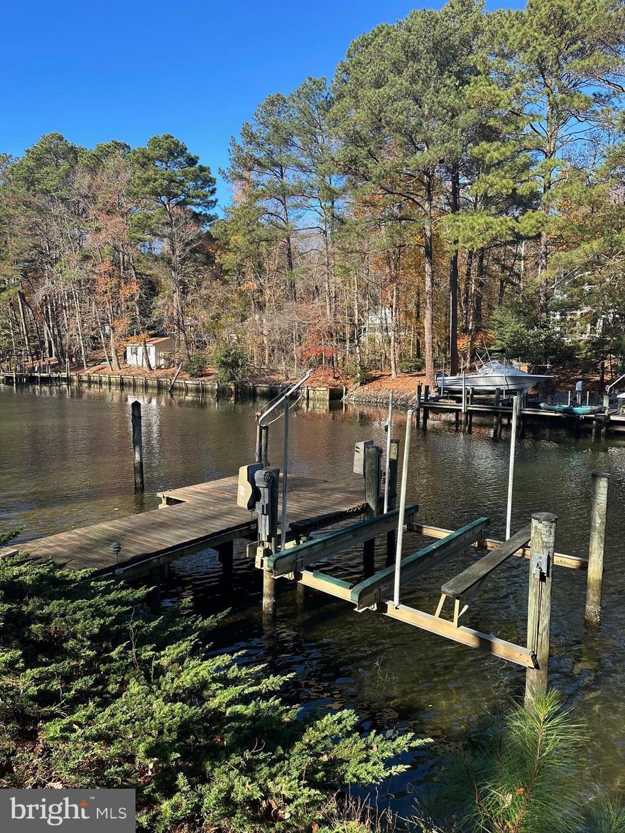 Perfect Waterfront Retreat. Move-in ready. Large living room, Hardwood  floors. Gas Fireplace. Large Kitchen overlooking Mill Creek. Large Owners Suite with walk-in closet. New Carport in all bedrooms.
Deck access from living room and owners suite. Full lower level with sliders to additional deck. Walkway to pier. Boat Lift and slip.