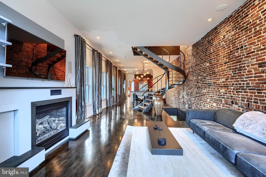 Introducing 1301 Hull Street where no details were overlooked in this Impeccably designed home that exudes style and class.  This stunning residence boasts custom woodwork, Brazilian Cherry in-laid Hardwoods, Imported Travertine tile floors in the Gourmet Kitchen to include custom cabinetry w/ wine rack, tiled back splash, an Induction Cooktop, Oven and Double -Door Sub-Zero refrigerator.   The living features a Custom Built-In Entertainment center w/ ambient fireplace, exposed brick wall and custom Spanish Cedar Front Door.  Expansive owner's suite w/ custom cedar lined closets and spa inspired bath, large soaking tub and separate shower w/ steam options & dual shower heads.  Custom interior Douglas Fir doors from Canada w/ Baldwin hinges and doorknobs.   Rear patio can easily convert to parking (curb cut is in place).  Potential to add 5th bedroom in LL, Deck off 3rd fl rear bedroom & PARKING. Enjoy the best of city living located in the vibrant Locust Point neighborhood with local parks, shops, dining