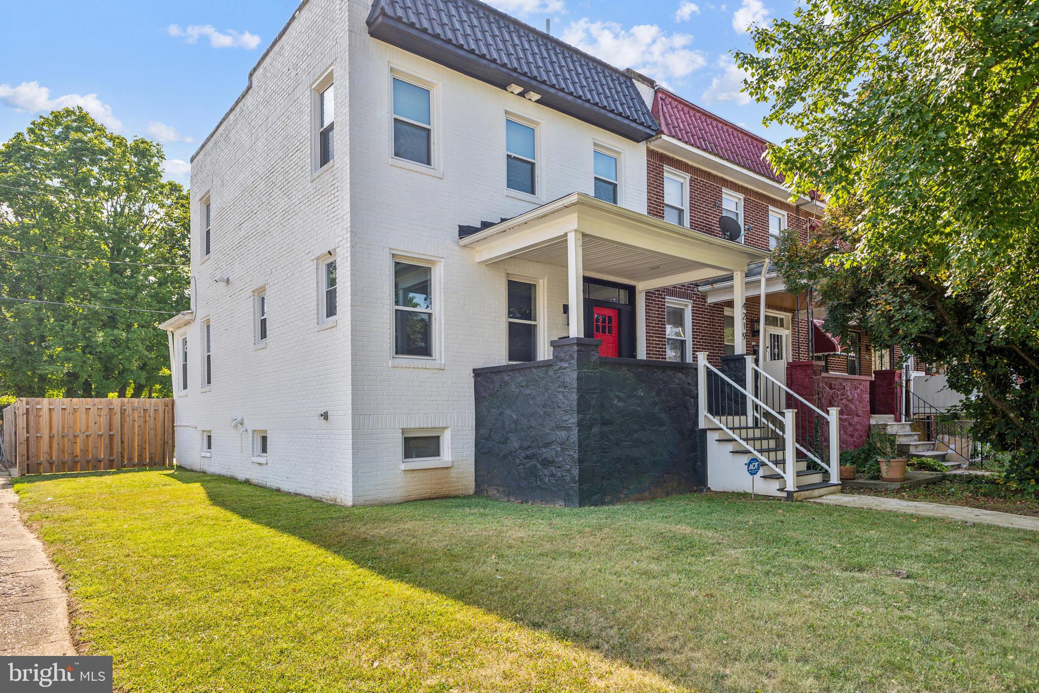 Welcome to this stunning, fully renovated end-unit townhouse, where modern luxury meets timeless charm. Spanning three finished levels, this beautifully upgraded home offers an ideal blend of elegance, space, and functionality—perfect for families or individuals alike.
Upstairs, you'll find three generously sized bedrooms and two full bathrooms, including a serene primary suite with a spacious walk-in closet and a private en-suite bath. The secondary bedrooms are styled in a soft gray palette with crisp white trim, creating a bright and airy ambiance that suits a variety of needs.
The heart of the home is the modern kitchen, showcasing sleek white cabinetry, a bold black hexagonal tile backsplash, and elegant globe pendant lighting over a white marble countertop that doubles as a breakfast bar. An adjacent open-concept dining and living area is bathed in natural light from large windows and features stylish gray wood-look flooring throughout.
Outside, the home's striking white facade is accented by a contrasting black wall and a vibrant red front door, enhancing both curb appeal and character. The neatly landscaped yard is enclosed by a wooden privacy fence along the side, adding to the home's inviting and secure feel.
The finished basement offers a cozy and flexible space—ideal for a media room, guest suite, or home office—and includes a full bathroom, as well as an energy-efficient washer and dryer. Step out back to a fenced-in yard with a small staircase and practical space for outdoor enjoyment or private parking.
Additional highlights include a newer HVAC system installed in 2022, ensuring year-round comfort.
Don’t miss the opportunity to make this beautifully updated home your own!