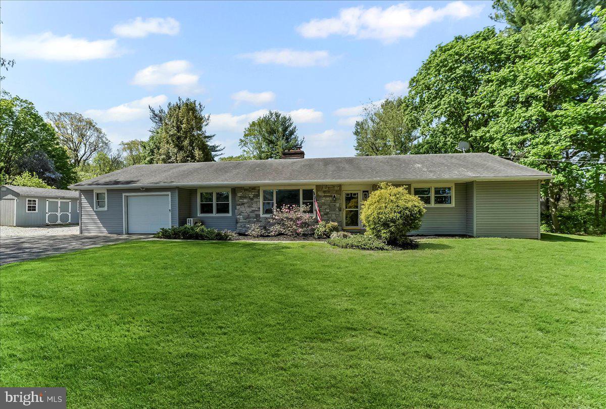 Welcome to 128 Elkdale Rd, a charming ranch-style home nestled on 7.8 acres in the peaceful countryside of Lincoln University. This beautiful home offers 3 bedrooms and 2.5 bathrooms, with over 2,200 square feet of total living space. The spacious living area features hardwood floors throughout and a cozy stone fireplace with a wood stove, creating a warm and inviting atmosphere. The primary suite includes an en-suite bathroom with a tiled tub/shower combo, while the oversized second bedroom (19’x10’) offers ample space. A partially finished walk-up basement adds even more versatility to the home, with two recreational rooms, a sports bar area, a brick fireplace, and a half bath. The basement is outfitted with luxury vinyl plank and ceramic tile flooring. Outside, you’ll find a 13’x10’ covered stone porch that overlooks the lush backyard and wooded surroundings, perfect for relaxing or enjoying a meal outdoors. The 24’x21’ patio with a fire pit is ideal for entertaining or quiet evenings under the stars. The expansive 7.8-acre property includes trails cut through the woods, offering opportunities for hiking, hunting, or side-by-side riding. The home is equipped with mini-split systems installed in 2018 and new windows were added in 2012. For convenience, the first-floor laundry and mudroom are located just inside the 2-car garage. This property offers the best of both worlds—seclusion and tranquility, with easy access to major travel routes such as Route 1 and I-95, making it perfect for commuters. Whether you’re looking for a country retreat, a small farmette, or just a peaceful home with plenty of room to grow, 128 Elkdale Rd is an exceptional opportunity.