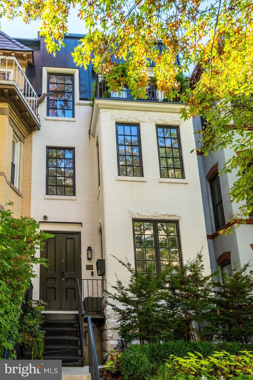 This stunning Victorian rowhouse is situated on a lovely residential street and enjoys a location that puts all that Washington has to offer right at its front doors. The impeccably maintained home, which spans over 3,500 square feet, has undergone extensive renovations and features modern amenities, smart home technology, and custom finishes throughout. The entry level features a dramatic living room with a fireplace, large dining room, gorgeous half bath and beautifully appointed kitchen with custom cabinets and high- end appliances. A wall of French doors in the kitchen allow light to flood in and provides access to an expansive rear patio with room for outdoor living and multiple car parking. The first upper level is dedicated to the owners suite which boasts an extensive collection of custom closets with thoughtful details, a large and light filled bedroom with a fireplace, office nook and an expansive designer bathroom complete with Waterworks fixtures, a steam shower, heated floors and a freestanding bathtub. The second upper level is home to an elegant office with custom shelving and pocket doors, two well appointed bedrooms, two tastefully renovated bathrooms and a balcony with lush plantings. A rooftop retreat unlike any other can be found just above the top level. Featuring a dining area, generous entertaining space with a fireplace and a comfortable lounge area with remote controlled louvers, this truly exceptional space can be enjoyed all year long. The lower level has a separate entrance that allows access to a large bedroom, high end bathroom, custom gym with steam shower, family room and laundry room. Abundant storage options are found throughout this level as well as a Subzero wine fridge with space for 130 bottles. With four finished floors featuring the highest level of craftsmanship and detail, secure parking for up to four cars and an elevator serving each floor including the roof top oasis, this home represents the finest in modern living.
