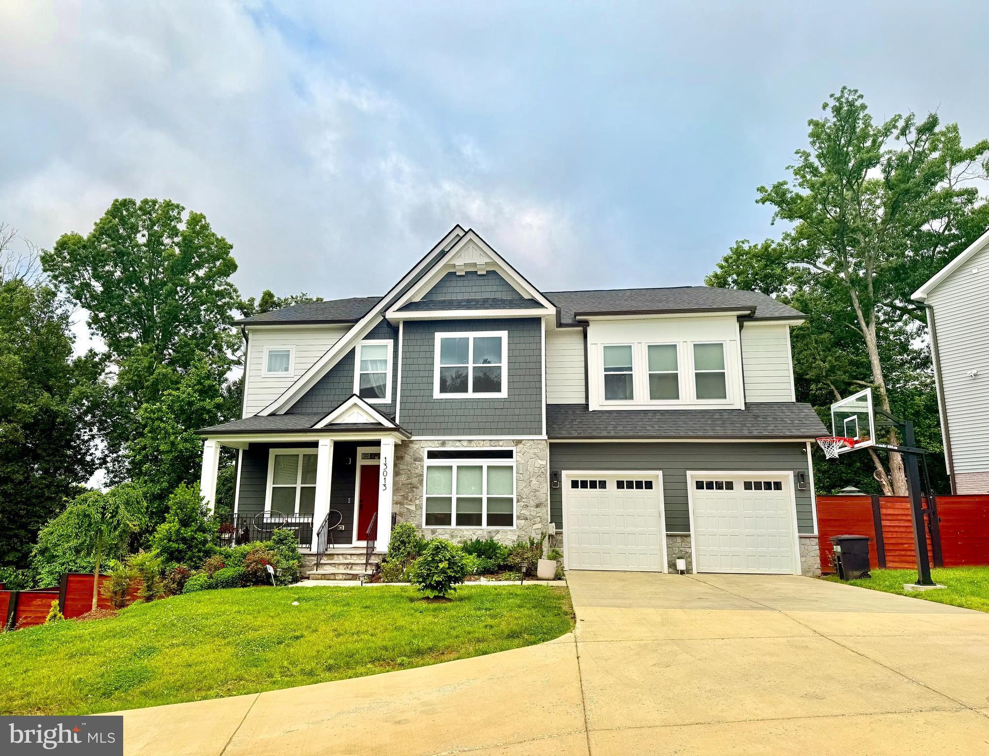 Newly built in 2021, this exquisite 5 bedroom, 4.5 bath home boasts nearly 5,000 sq ft of luxurious living space. Located in Fairview Estates, a picturesque six home community, this classic Colonial home includes many upgrades including a welcoming front covered porch and so much more. Nestled on a sun-soaked 1/3 acre lot situated on a beautiful cul-de-sac, this grand residence welcomes you with open arms, boasting timeless architectural design and unparalleled craftsmanship. The main level presents a seamless flow with 7" luxury vinyl plank throughout living, dining and kitchen spaces. A thoughtfully designed home office and a convenient powder room offer practical spaces for work and guests. The heart of the home is the grand family room, featuring stunning coffered ceilings that enhance the sense of space and light. This room opens gracefully to an eat-in kitchen, a culinary haven for any chef, complete with a chef's kitchen, a huge island, tile backsplash, quartz countertops and spacious pantry. Custom built-ins have been installed throughout. Practicality meets style with a mudroom that leads to the two-car garage that is plug-in ready. Recessed lighting and accent walls throughout the entire home adds a touch of modern elegance. Ascend to the upper level, and a luxurious primary suite awaits with a spa-like bathroom featuring two vanities, shower, and a relaxing soaking tub. A second bedroom enjoys the privacy of an ensuite bathroom, while bedrooms three and four share the third bathroom, providing convenience and comfort for all. The fully finished walkout basement and massive rec room is a haven for entertainment and relaxation. Boasting a bedroom and a private full bathroom, which serves a great guest room or in-law suite. Don't miss the exercise room and the additional storage. This space seamlessly connects to the sprawling backyard, which opens to wooded surroundings, offering a private oasis for outdoor activities and enjoyment. The 400 square foot deck with a convenient cut-out for grills is great for outdoor entertainment and grilling in the summer months. Stunning landscaping in both front and back yards. Don't miss this incredible home conveniently located near Route 29, New Hampshire Ave, and the ICC.