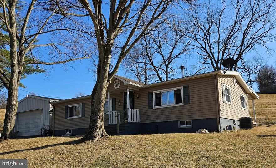 2 + acres in Stoverstown. Convenient to Southern York, Hanover & West York. 1975 double-wide with a full walk up basement. 3 bedrooms, 1 bath. Relaxing, private covered rear porch to unwind and enjoy your favorite beverage. Huge garage with a seperate 100 amp electric service. Easily store 4 cars and/or all your toys.  Property being sold AS-IS.