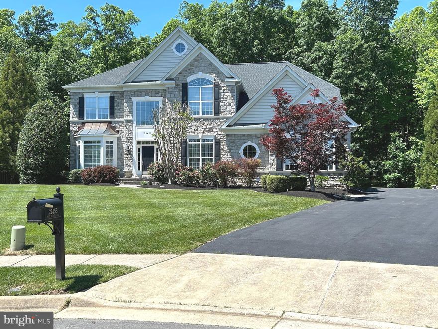 NEWLY UPDATED & MOVE-IN READY! This stunning executive home has been beautifully refreshed with stylish contemporary flooring, new carpet and an upgraded kitchen & butler’s pantry featuring crisp white cabinetry and quartz countertops—truly showing better than ever!

Tucked away on a quiet cul-de-sac in one of Ashburn’s most sought-after neighborhoods, this exceptional 5-bedroom, 5.5-bath, 3-car garage home offers over 6,000 sq. ft. of elegant living space across three finished levels, set on a private half-acre wooded lot with usable yard space.

The main level is filled with wonderful architectural details including wainscoting, wall cutouts, niches and a dramatic staircase framed by a grand two-story foyer. The beautifully updated kitchen is ideal for both everyday living and entertaining and is complemented by a butler’s pantry with bar sink and beverage refrigerator. A spacious formal dining room provides the perfect setting for gatherings, and the home office features custom built-ins with a granite desktop and tranquil views of the yard. The inviting family room offers a cozy retreat centered around the brick fireplace.

Upstairs, you’ll find five generously sized bedrooms on one level, all with walk-in closets. Three bedrooms feature ensuite baths, while the remaining two share a buddy bath—perfect for larger households or guests. The primary suite is a true sanctuary, highlighted by a beautifully renovated luxury bath, complete with a standalone soaking tub and heated towel rack for ultimate relaxation.

The lower level delivers incredible entertainment space with the charm of a classic London pub, featuring a custom bar and pool table which conveys. Enjoy movie nights in the private home theater, plus a full bath, fitness room, and an additional unfinished bonus room currently used as a workshop.

Step outside to a park-like backyard oasis, ideal for entertaining or relaxing. Enjoy the screened porch with ceiling fans and Bose speaker system, or host summer cookouts on the flagstone patio with a built-in gas grill. As the sun sets, landscape lighting and a flagstone fire pit create a warm and inviting atmosphere. 

Conveniently located near the Ashburn Metro and the Brambleton Town Center, with restaurants, shops, library, movie theater, events, and even weekly farmer’s markets! 

This home truly offers the ultimate in memory making opportunities! Don’t miss your chance to schedule your private tour or visit the open houses. New Roof & HVAC (2022).