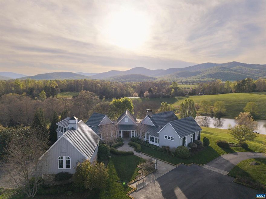 Grey Oaks is a magnificent 53-acre estate in Free Union, offering total privacy and stunning views of the Blue Ridge Mountains. Rolling meadows, mature oaks, tranquil streams, and two ponds?one stocked?create a breathtaking landscape. The custom-built residence by Shelter Associates boasts six bedrooms, six-and-a-half baths, and superb craftsmanship. A soaring great room with exposed beams and a fireplace anchors the home, complemented by a chef?s kitchen, elegant dining and breakfast rooms, and a cozy paneled den. The light-filled primary suite enjoys a private wing with his & her bathroom, while a separate three-bedroom guest/in-law retreat features a full kitchen, dining area, and loft-style family room with a fireplace. Extensive porches, a three-bay garage, an 1,800� sq. ft. barn, and no conservation easement enhance the property?s appeal. Walking trails, a charming creekside bridge, and raised garden beds complete this extraordinary offering. Only 15 miles NW of Charlottesville and the University of Virginia.,Granite Counter,White Cabinets,Wood Counter,Fireplace in Family Room,Fireplace in Great Room